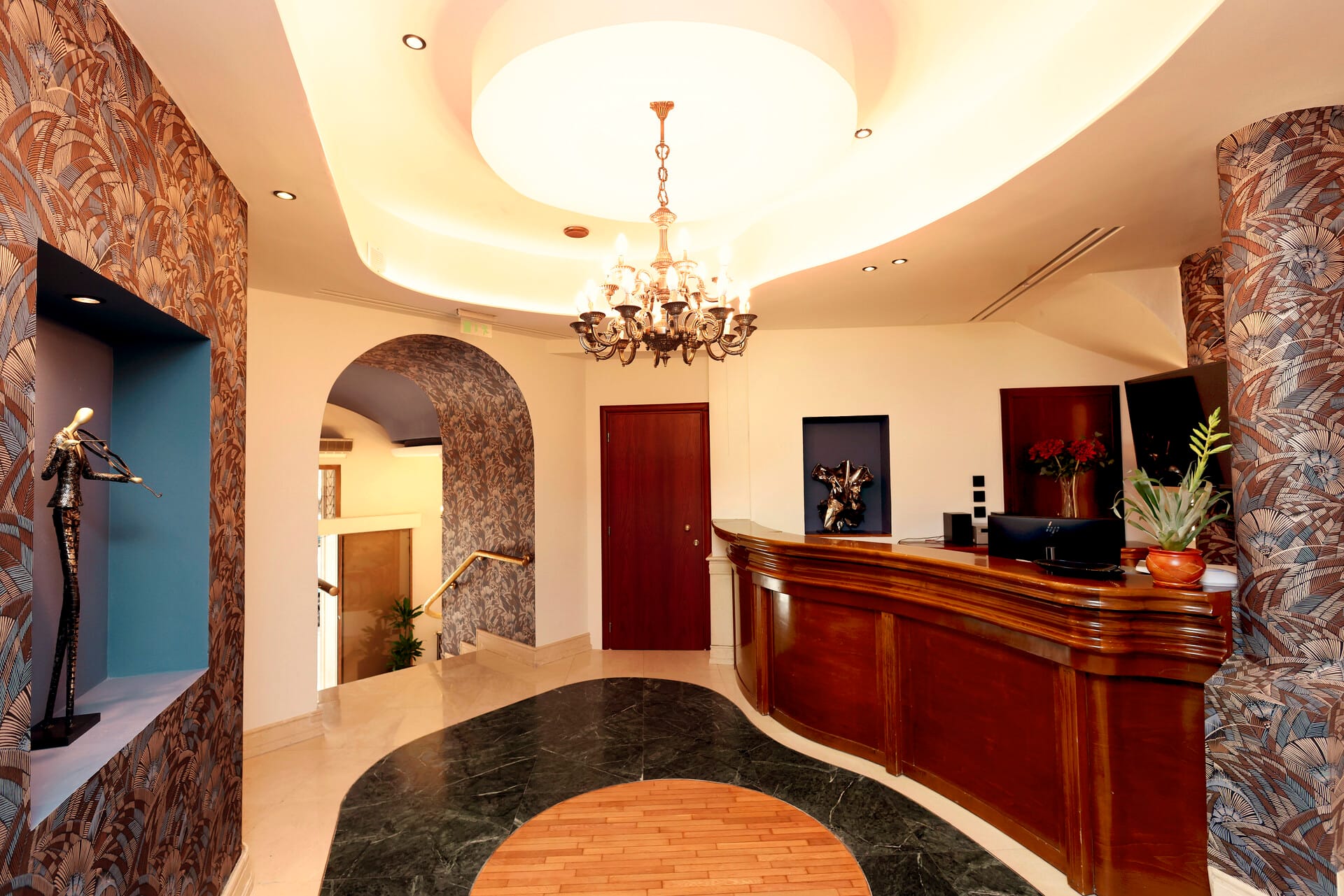 a large room with a chandelier and a desk