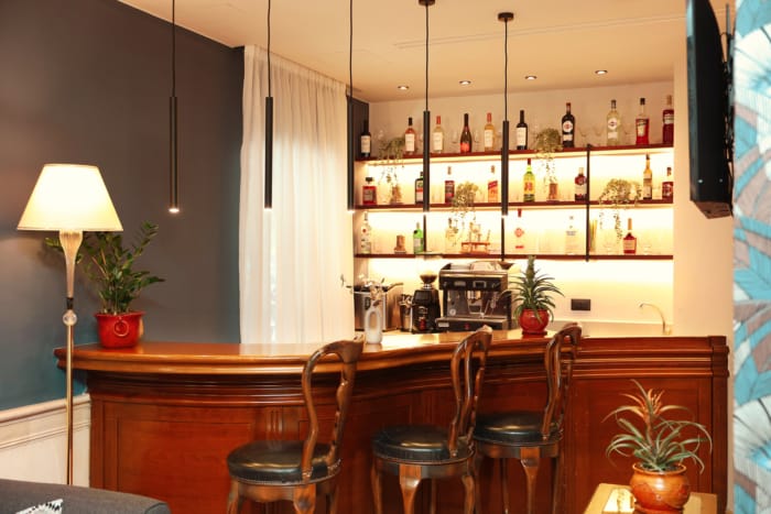 a kitchen with a bar and chairs