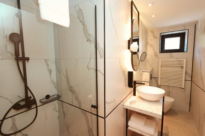 a bathroom with a shower and toilet