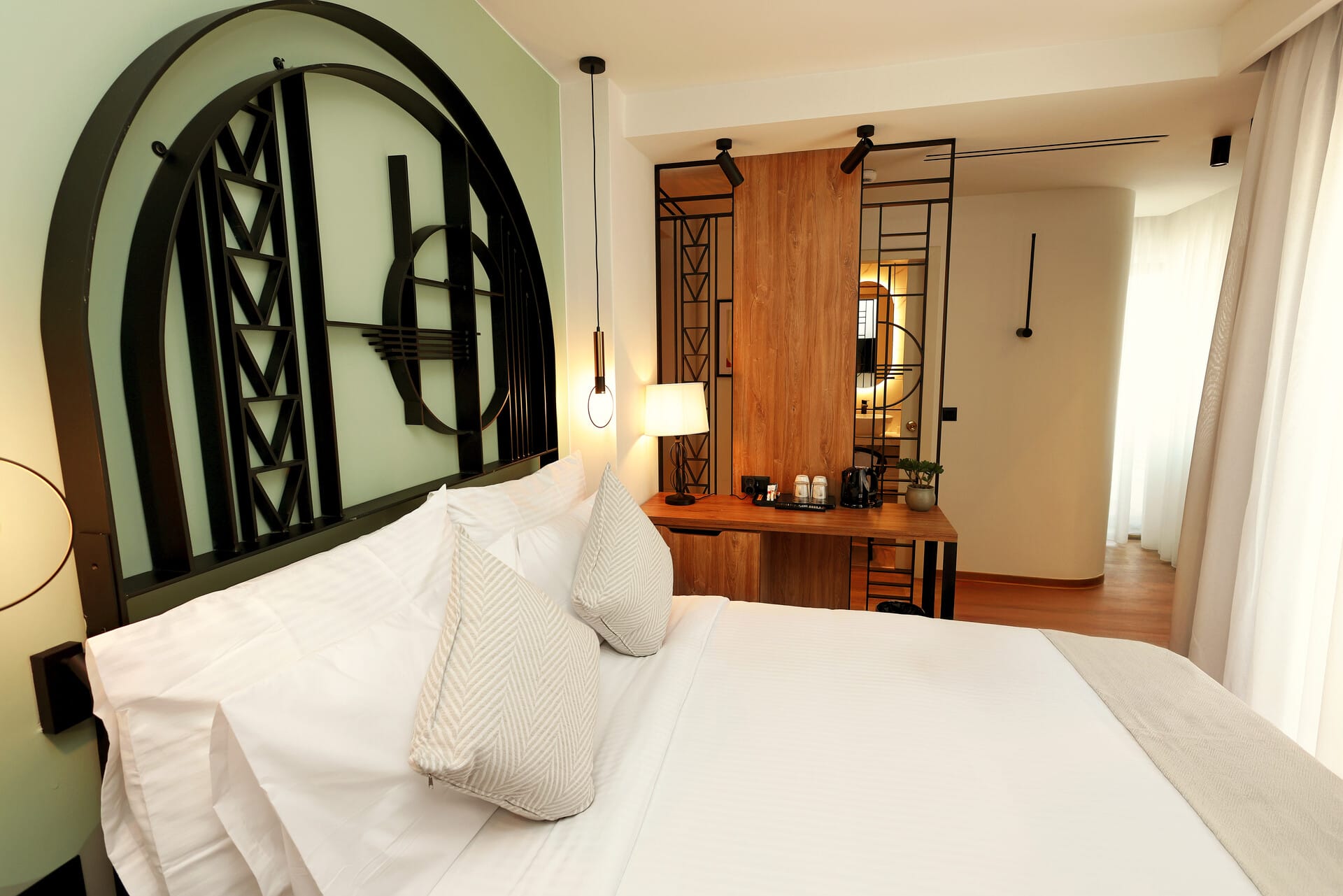 a bed with a mirror above it