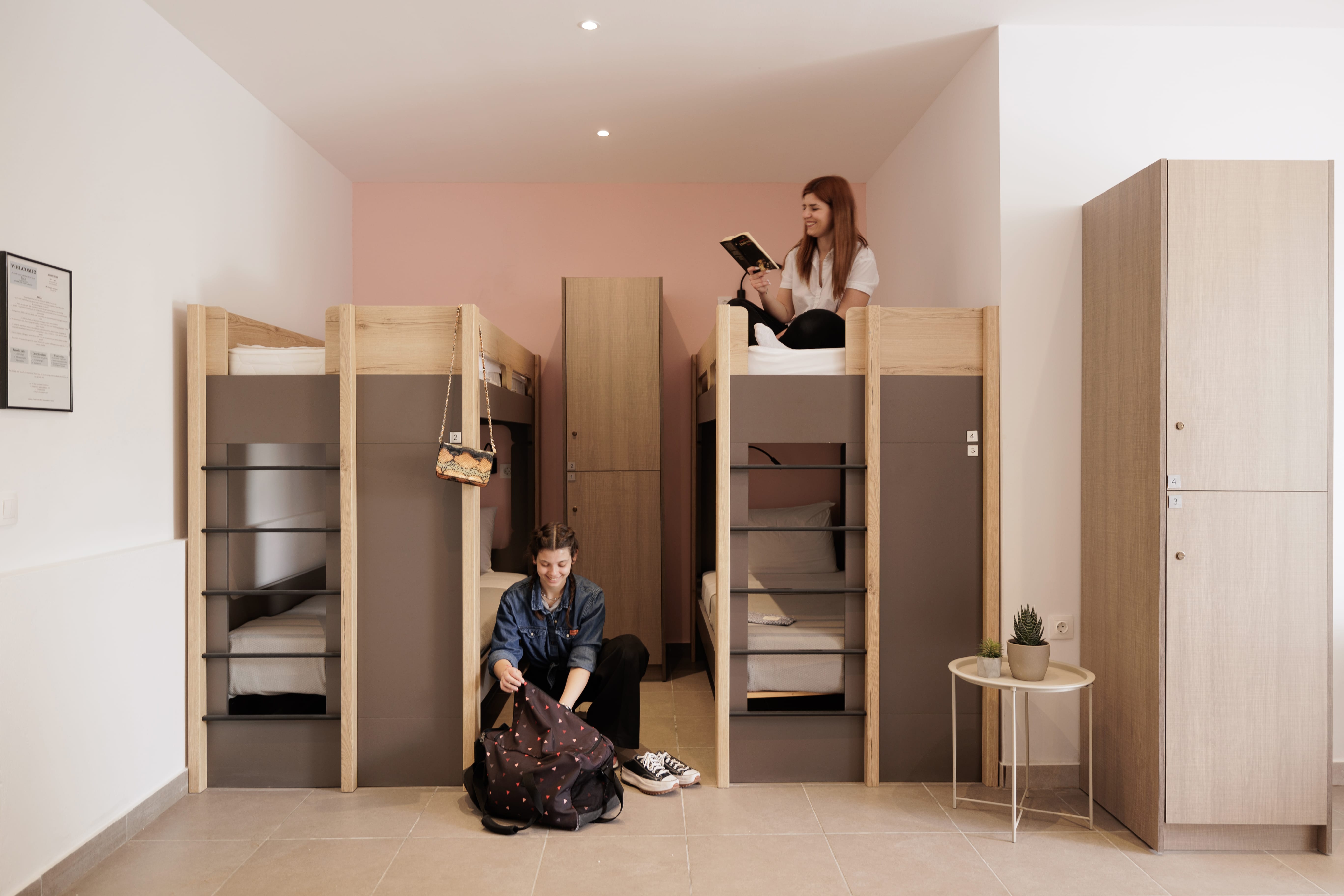 a woman sitting on a chair in a room with a man and a woman standing behind her
