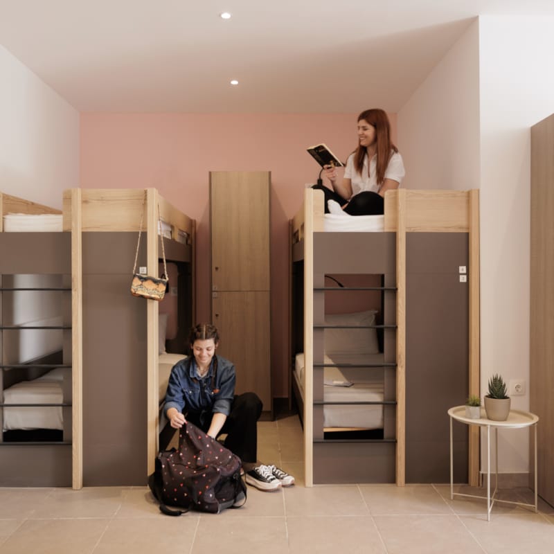 a woman sitting on a chair in a room with a man and a woman standing behind her