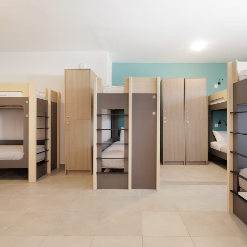 a room with shelves and a bed