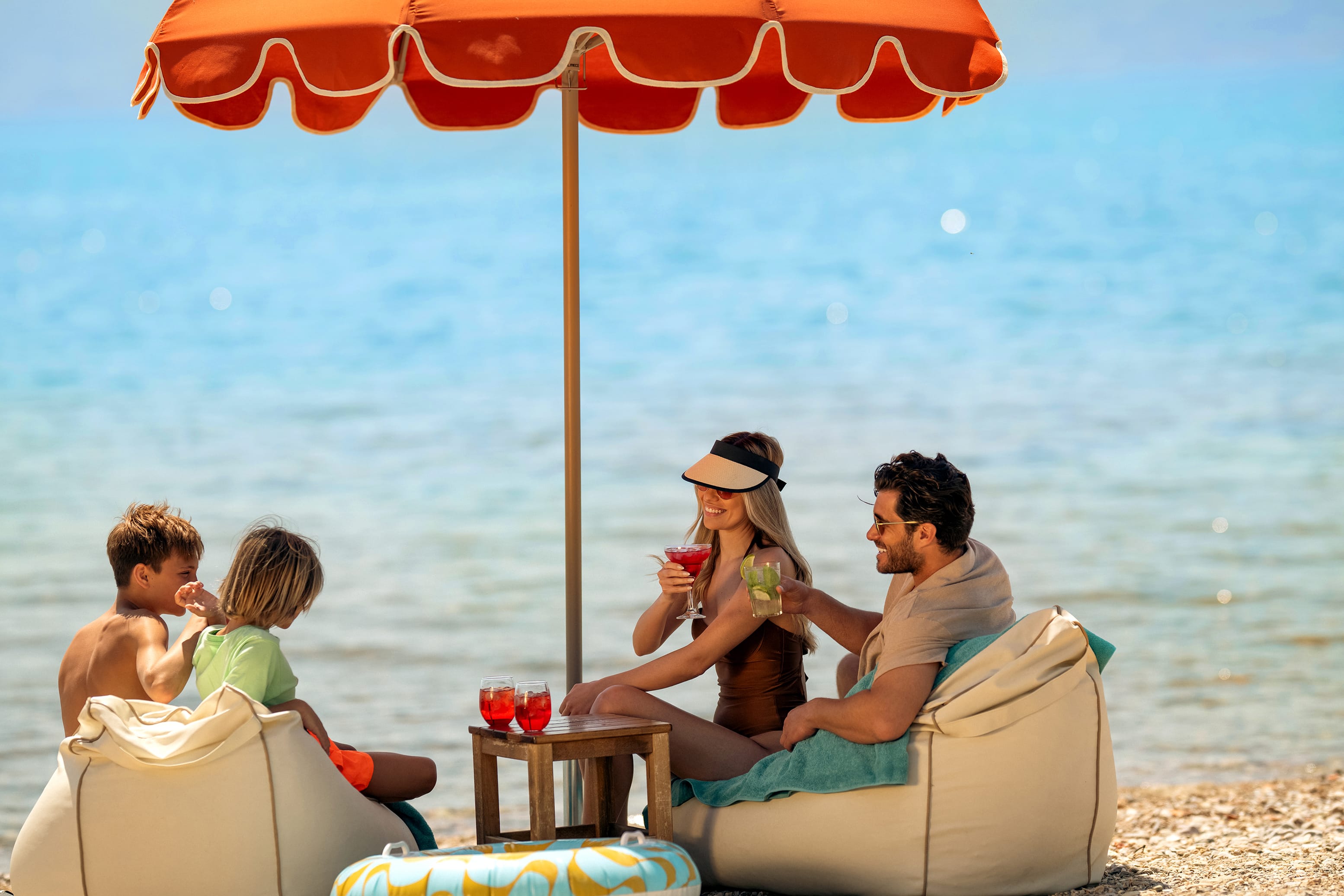 a family sitting on a beach