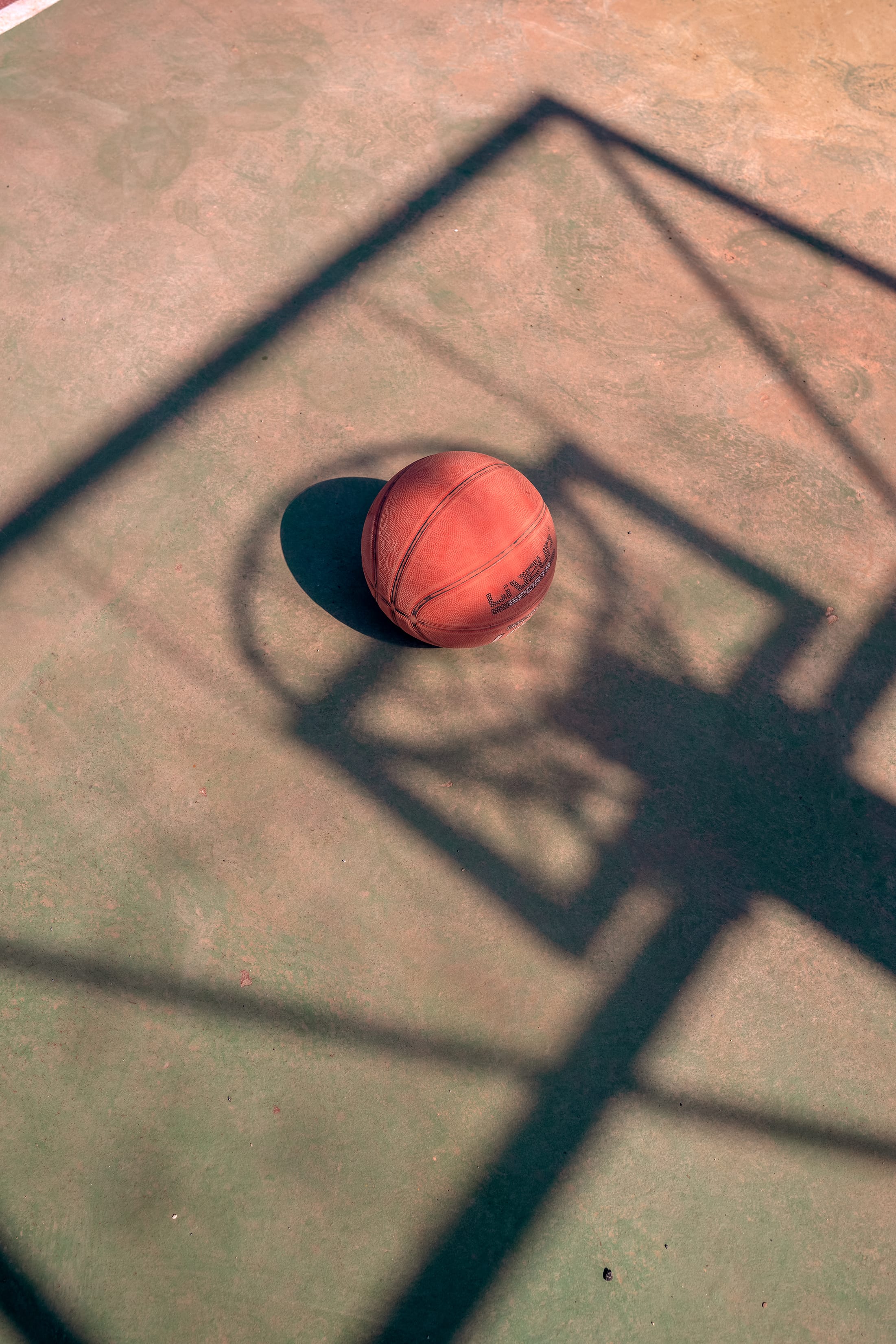 a red and black ball on a wooden surface