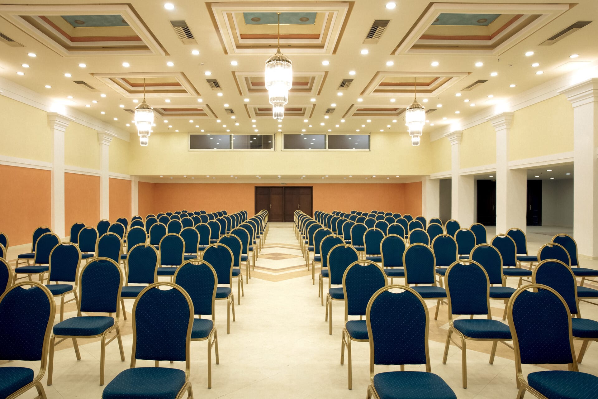 a room with rows of blue chairs