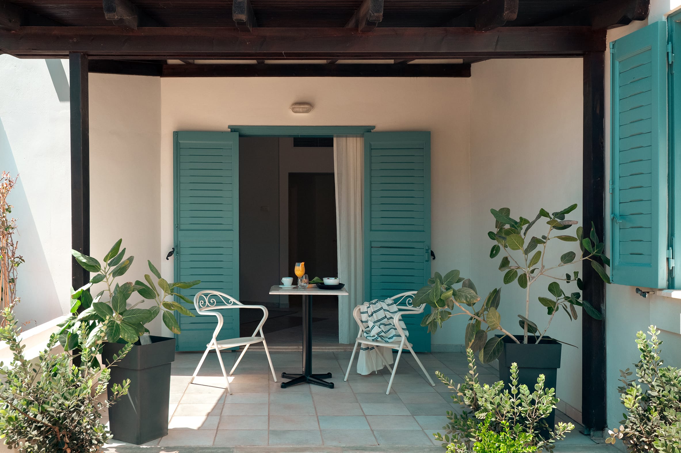 a patio with a table and chairs