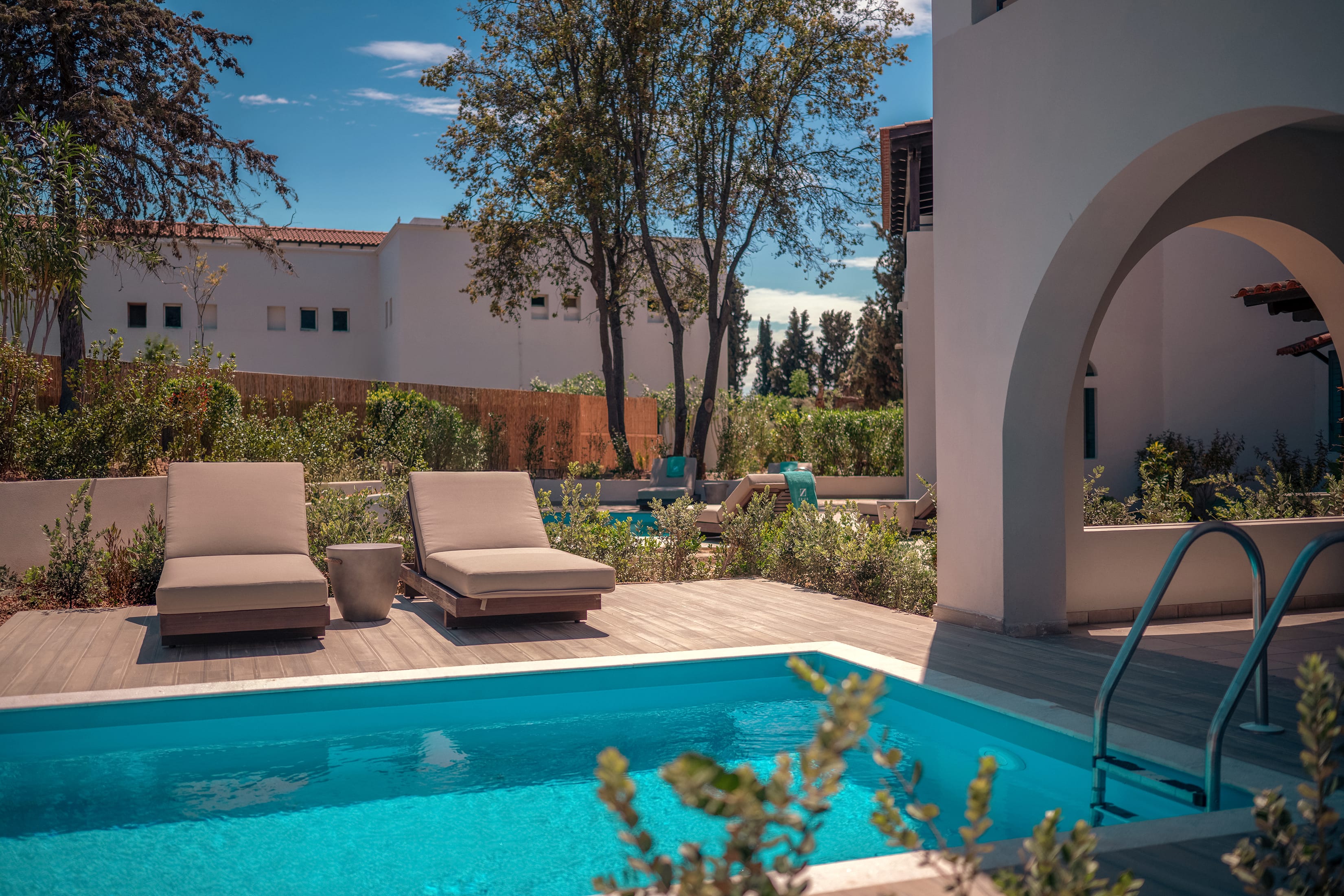 a pool with chairs and a deck