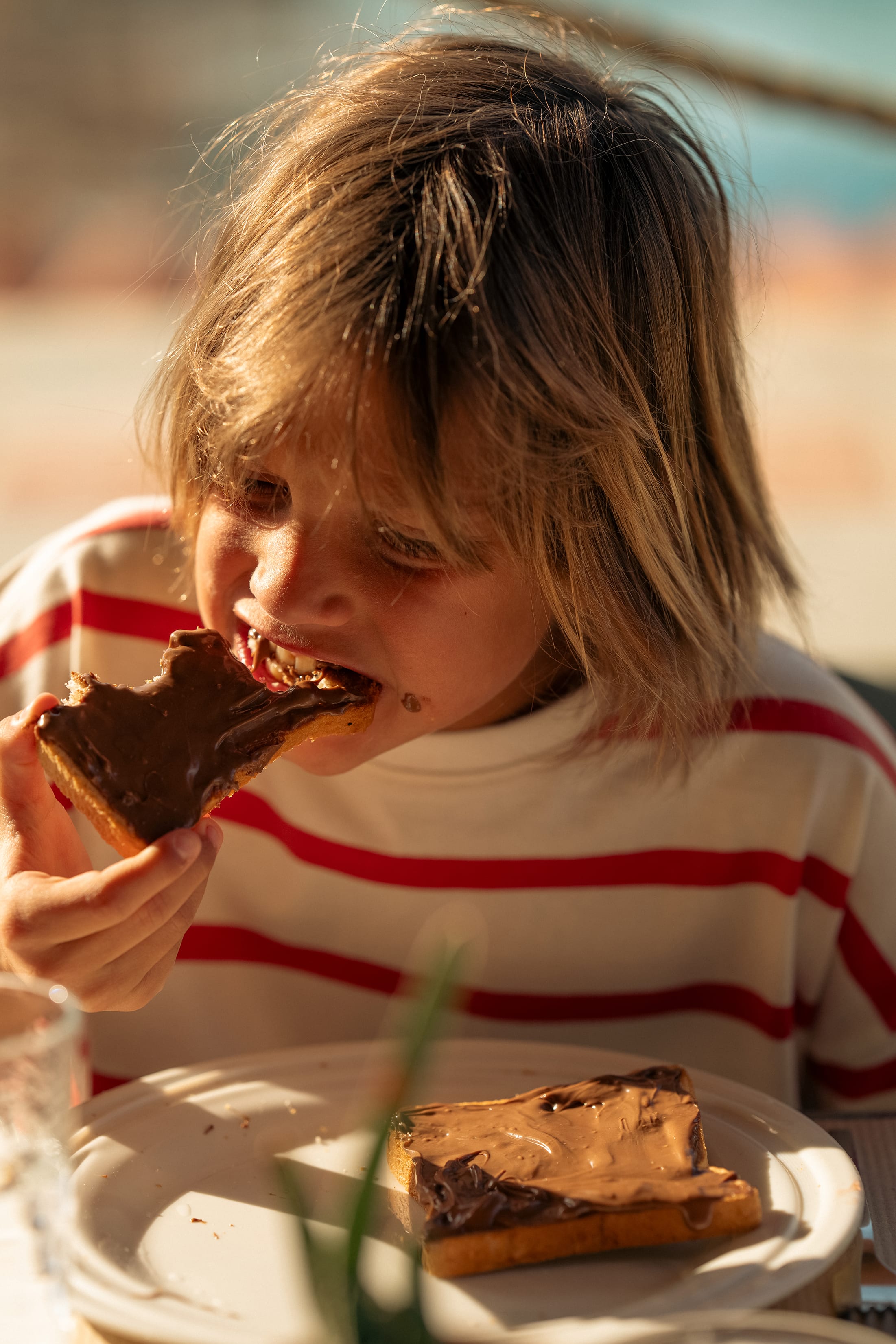 a girl eating a piece of cake