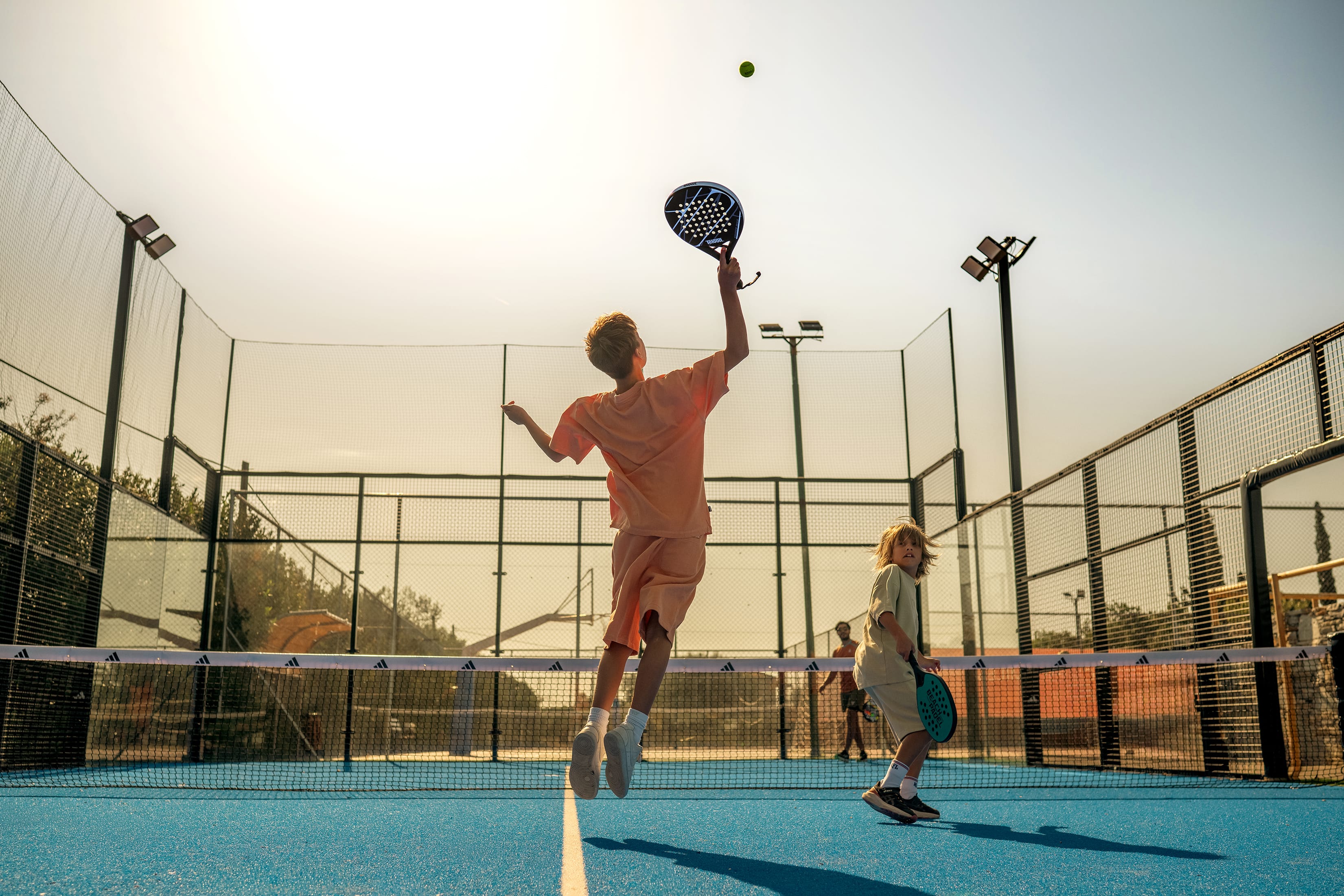 a man hitting a ball with a racket