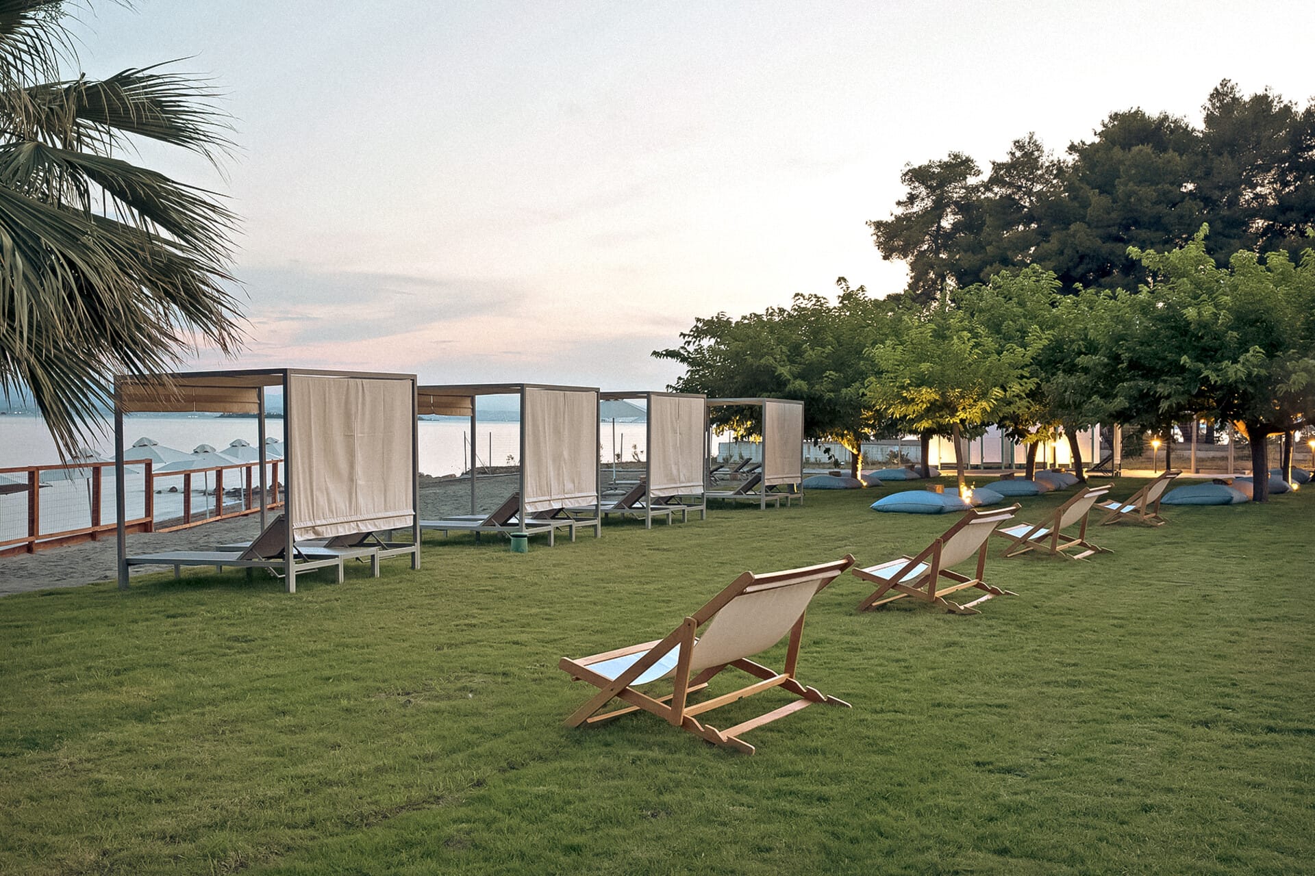 a lawn with chairs and a swimming pool