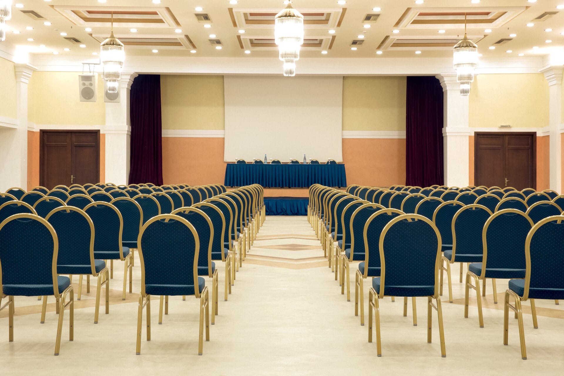 a room with rows of blue tables
