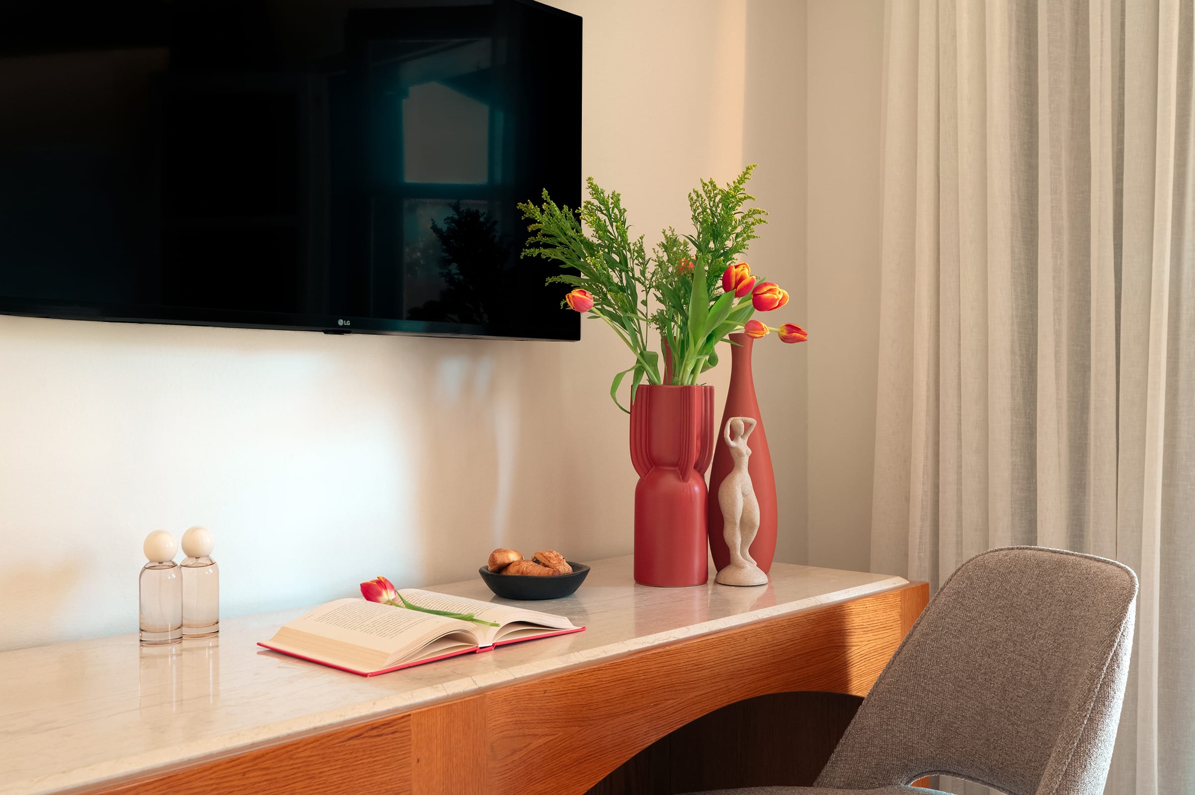 a couple of vases with flowers on a table