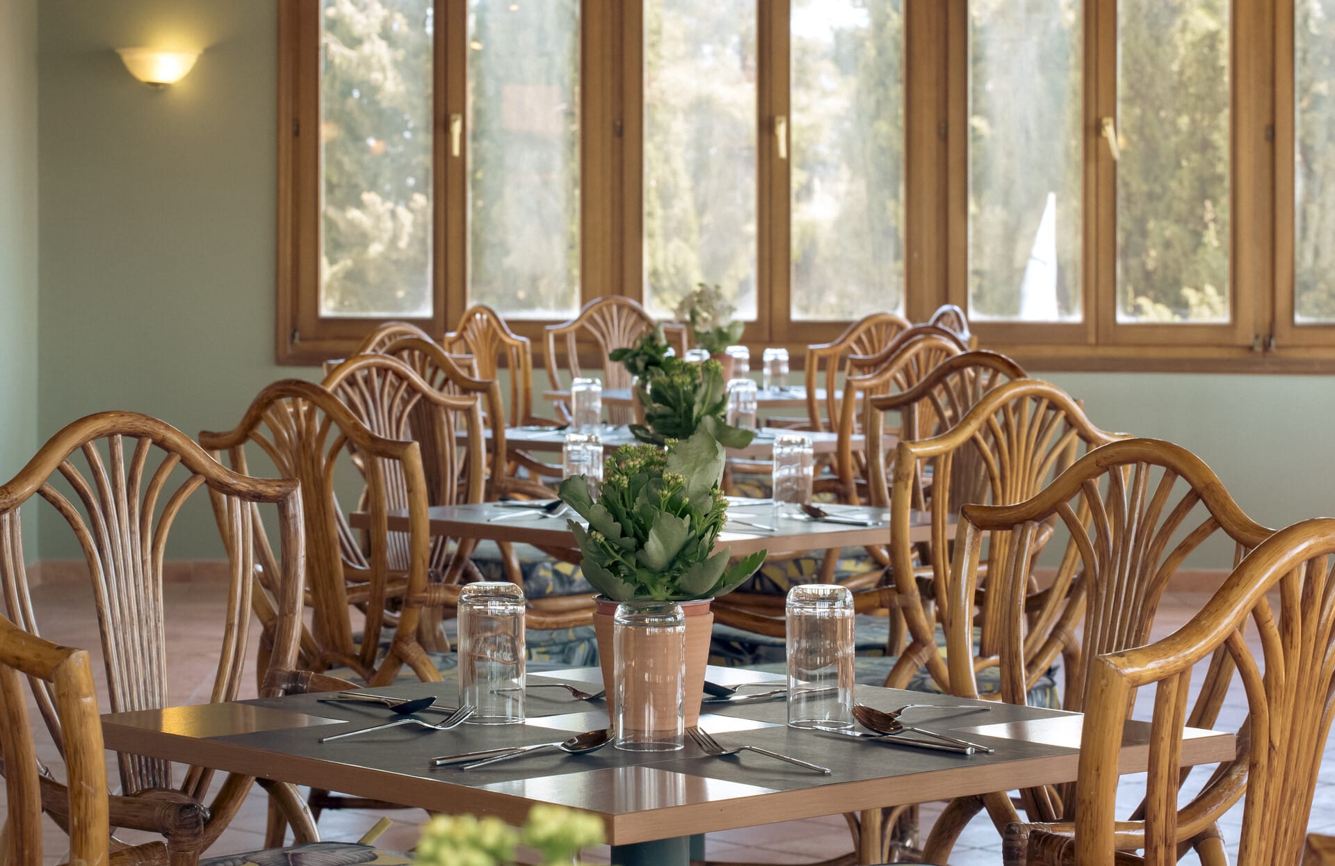 a dining table with a vase of flowers on it