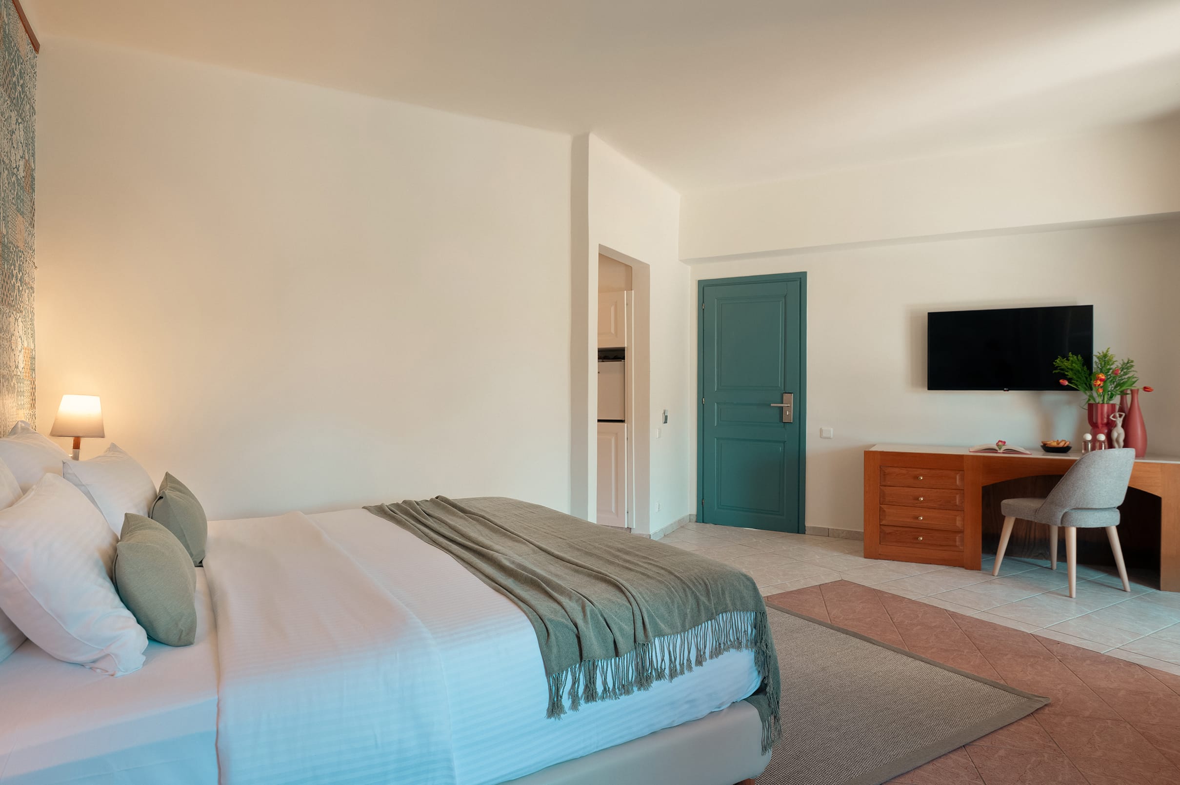 a bedroom with a bed and desk