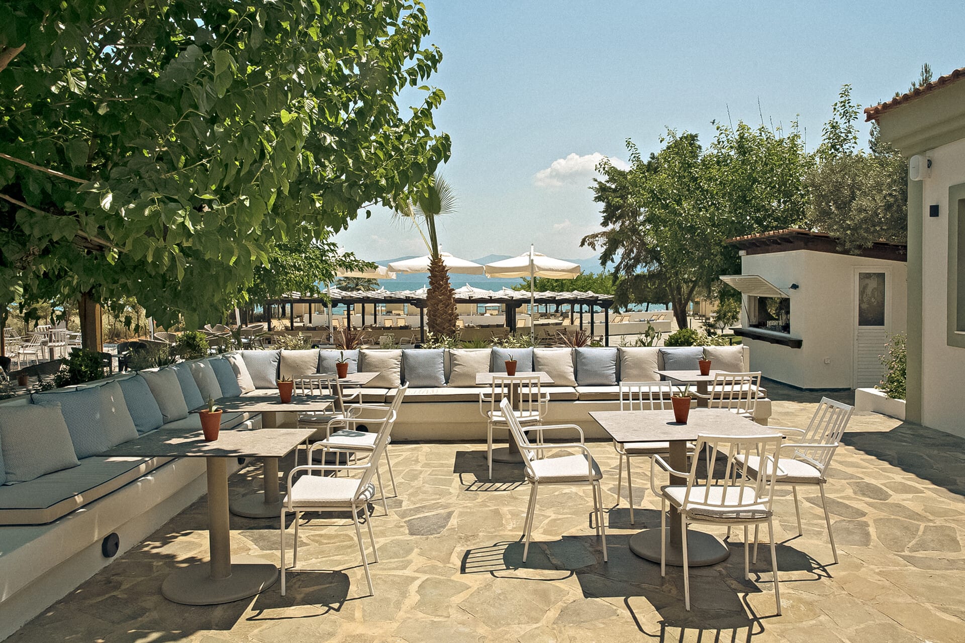 a patio with tables and chairs