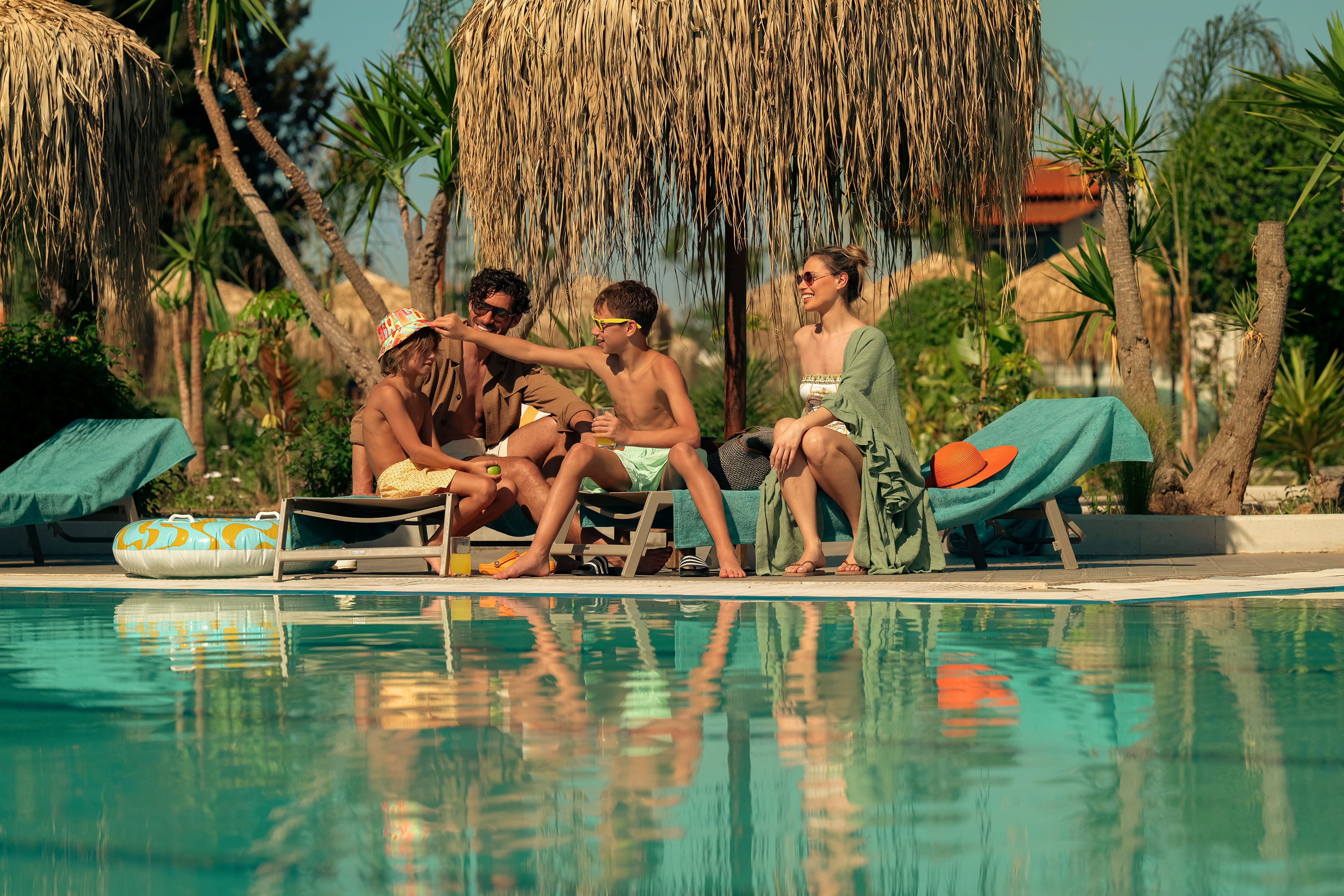 a group of people sitting by a pool