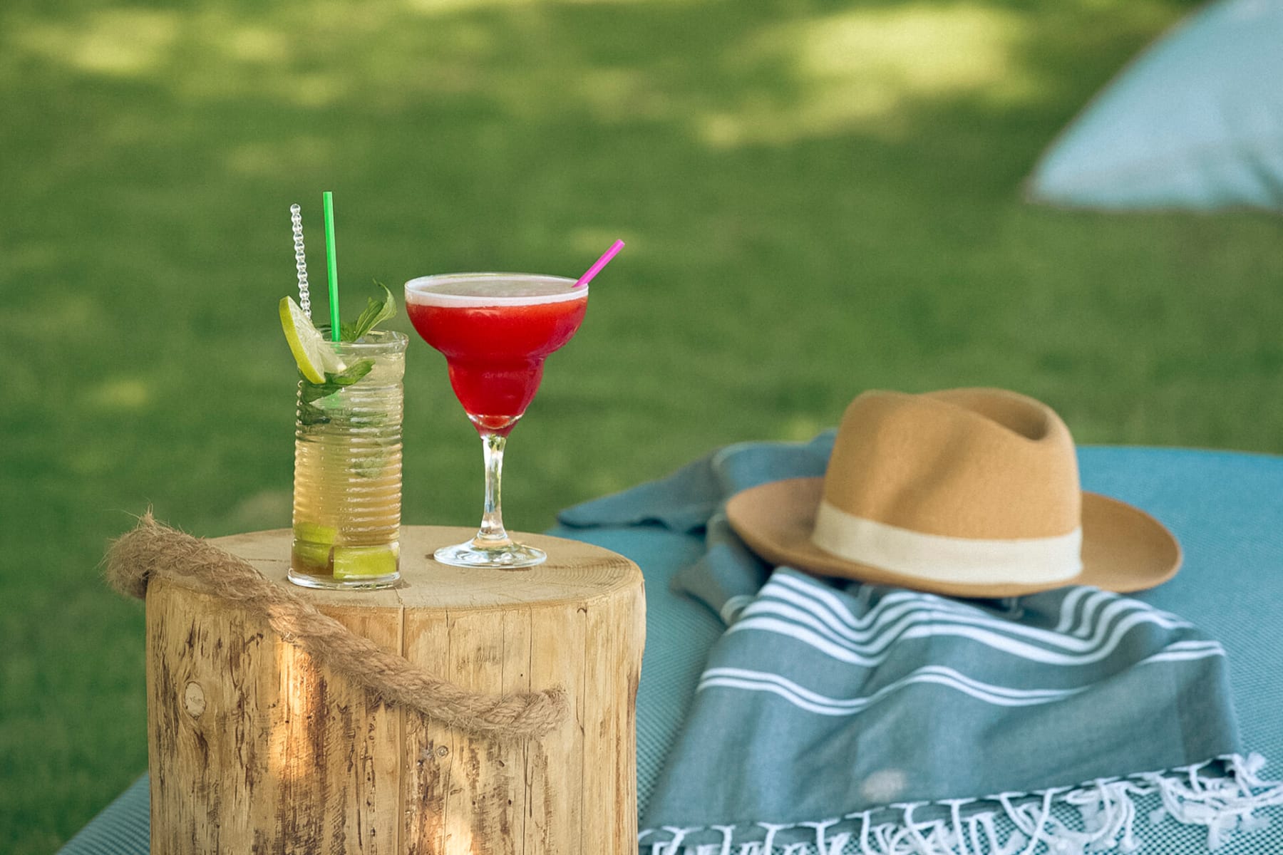 a hat and a drink on a table