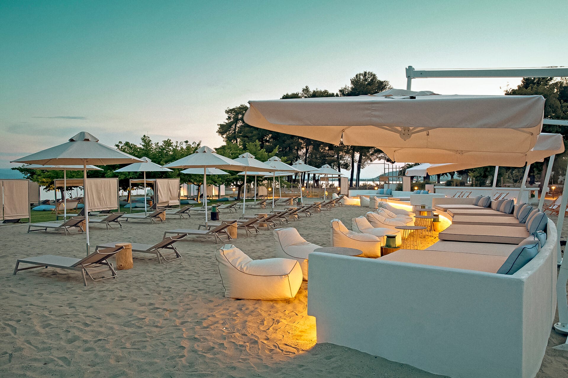 a beach with umbrellas and chairs