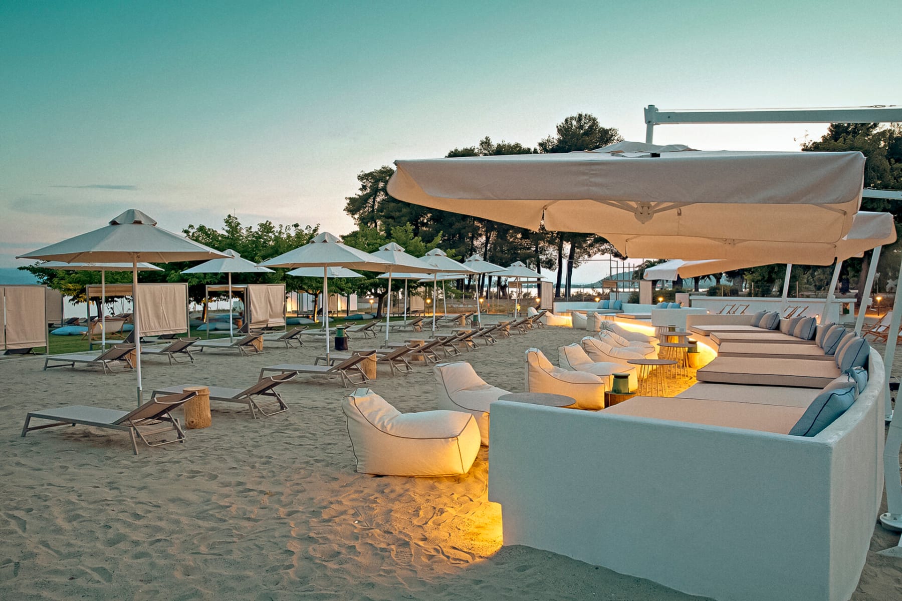 a beach with umbrellas and chairs