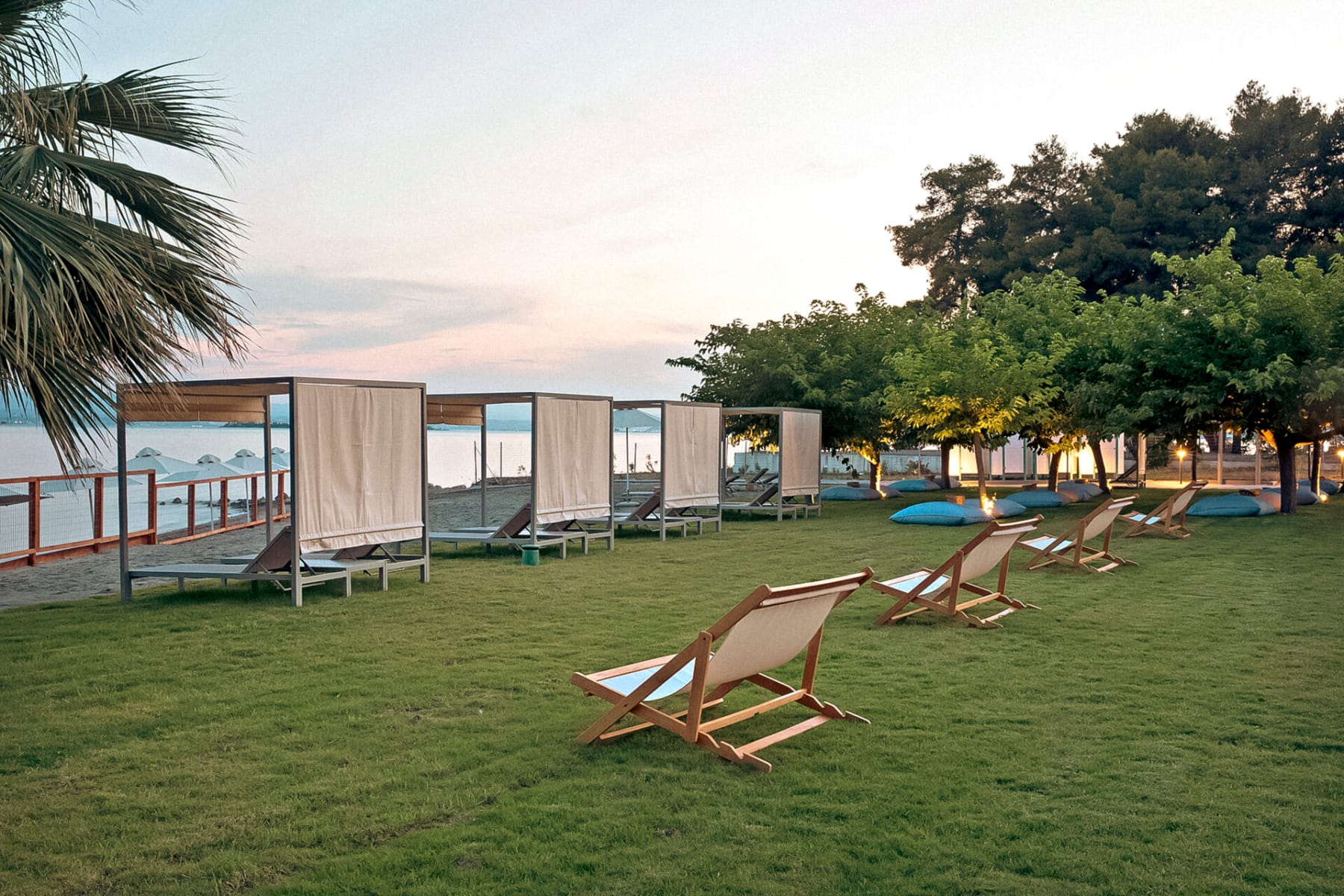 a lawn with chairs and a swimming pool