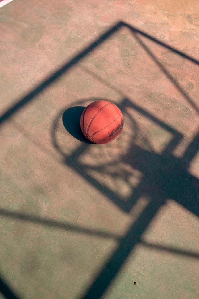 a red and black ball on a wooden surface