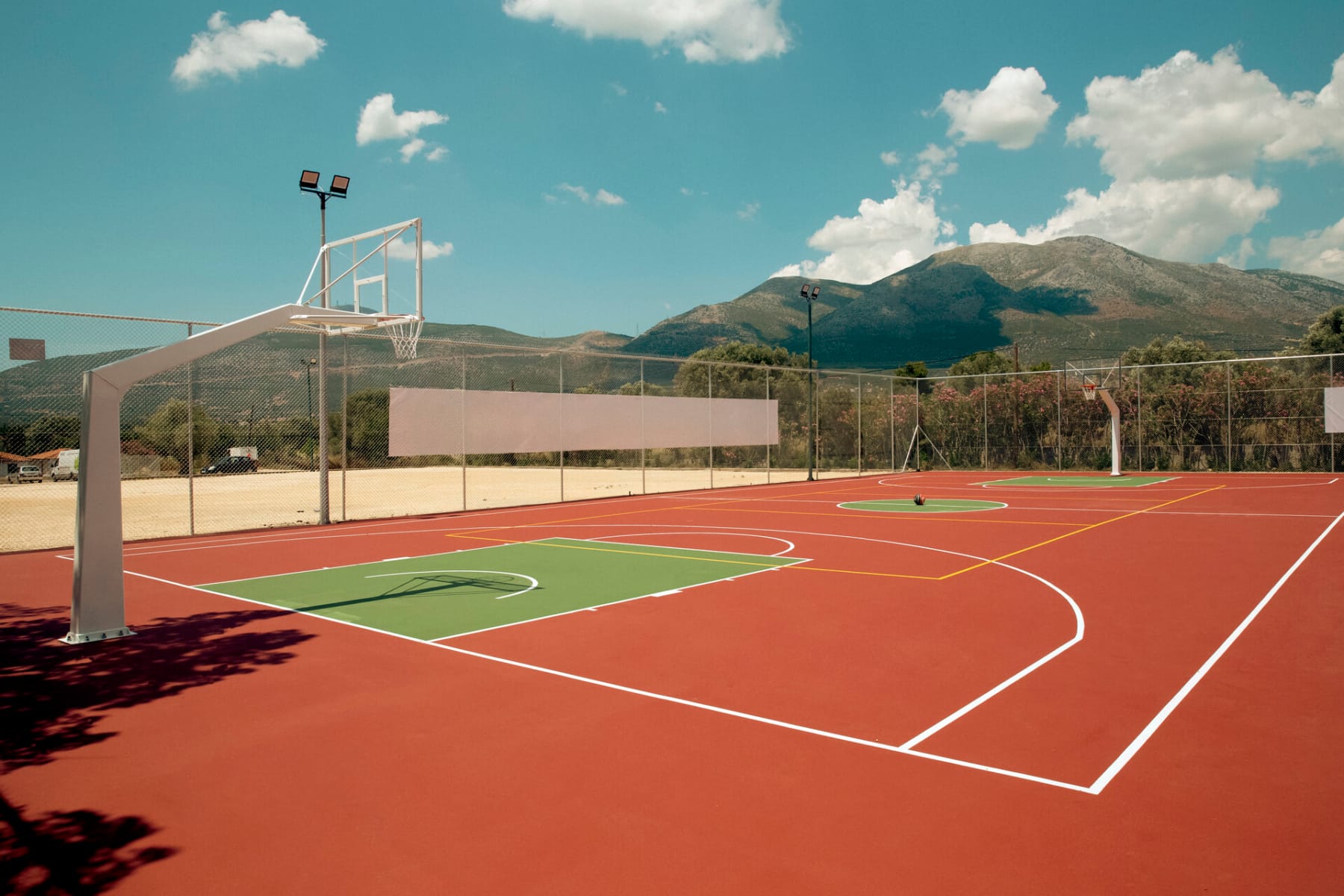 a track with a track and a field with a building in the background