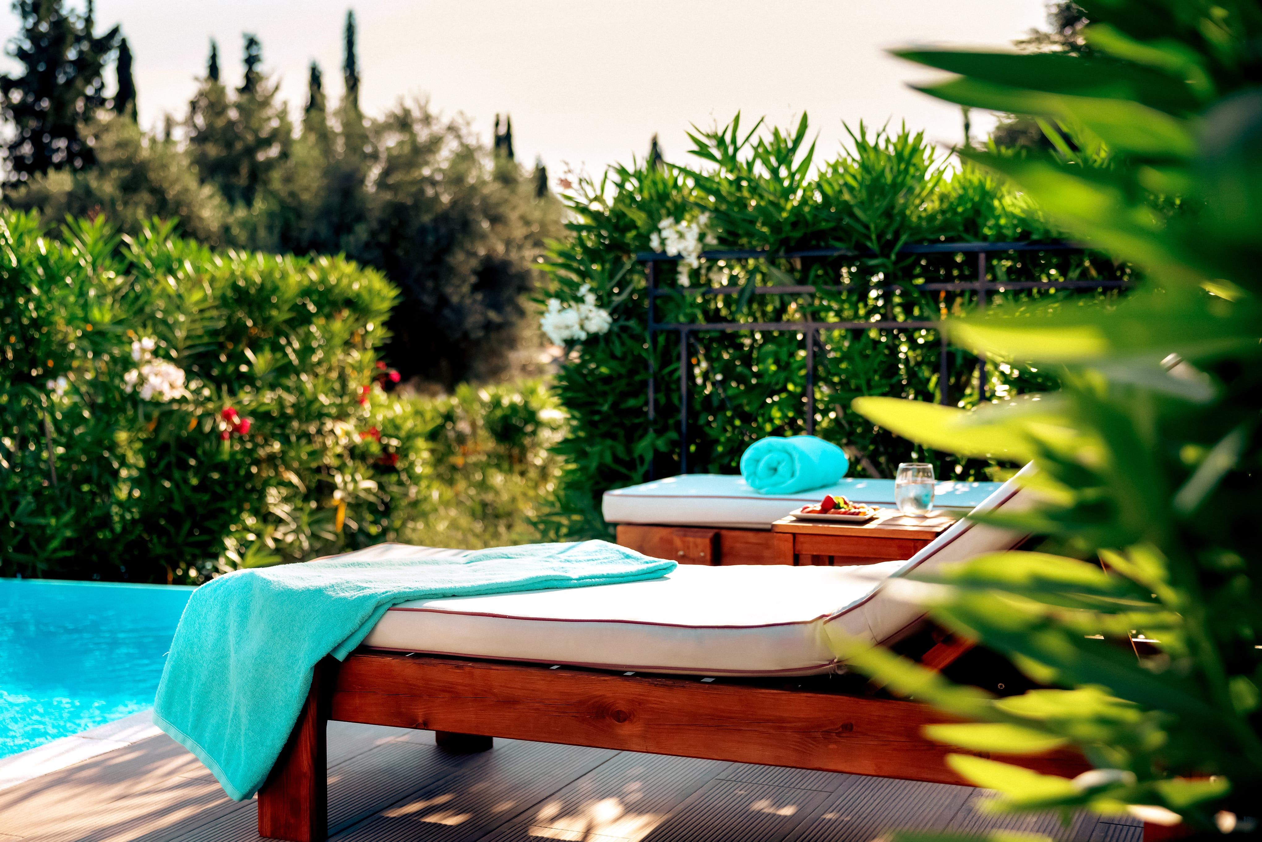 a deck with a pool and a hammock