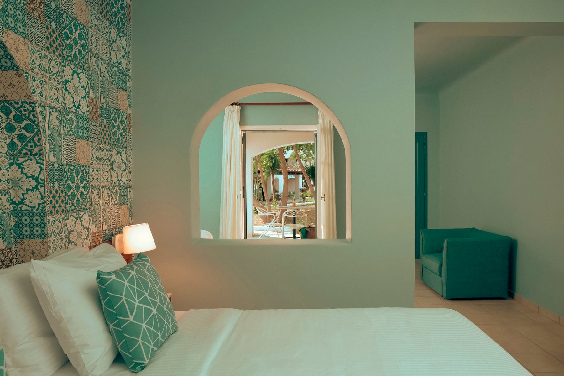 a room with a mirror and a bed