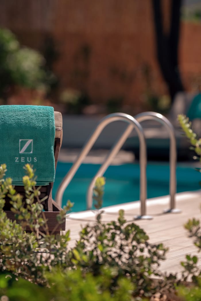 a bench next to a pool
