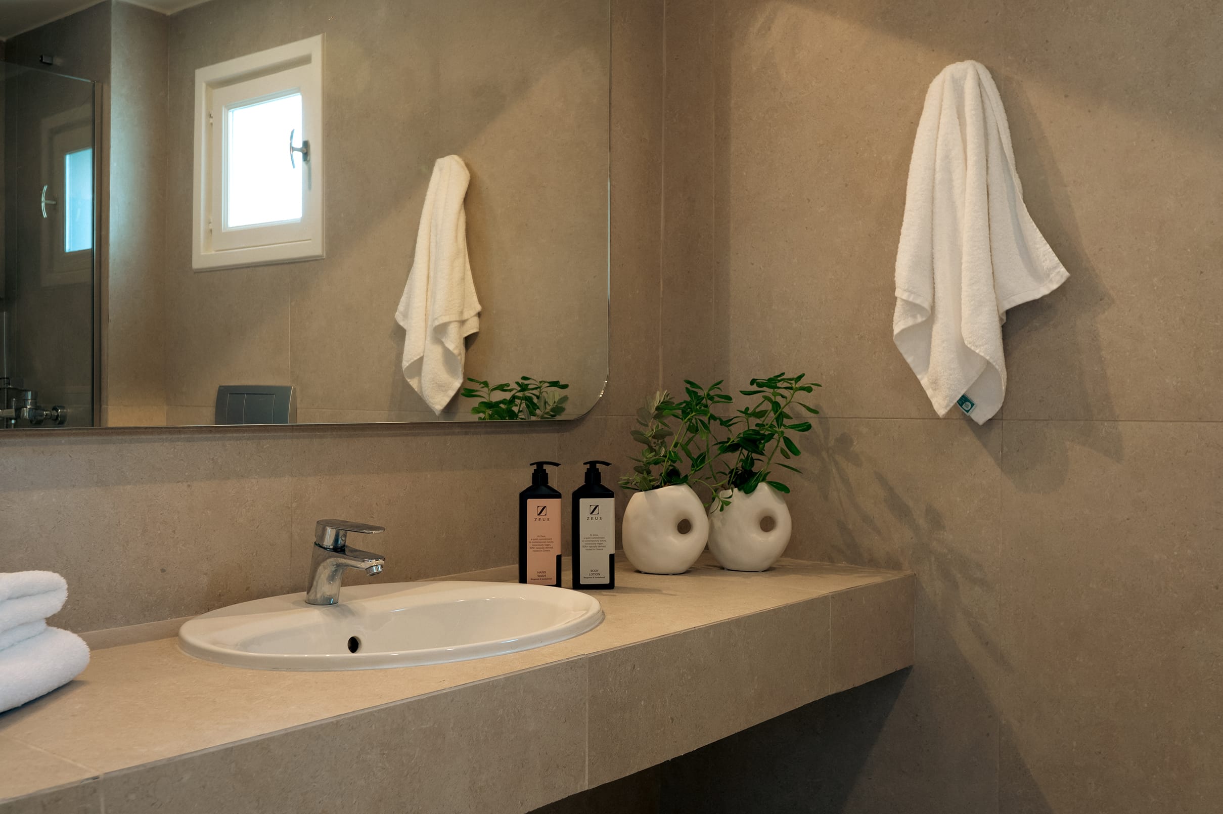 a bathroom with a sink and towels