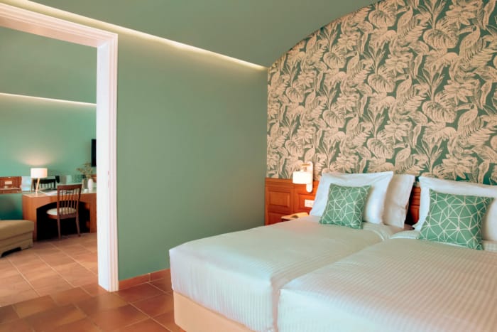 a hotel room with a bed and a desk