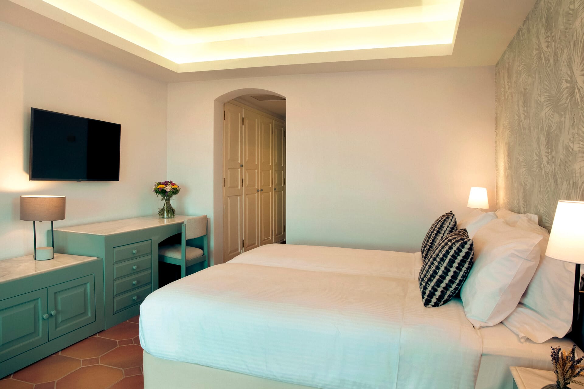 a bedroom with a bed and a tv