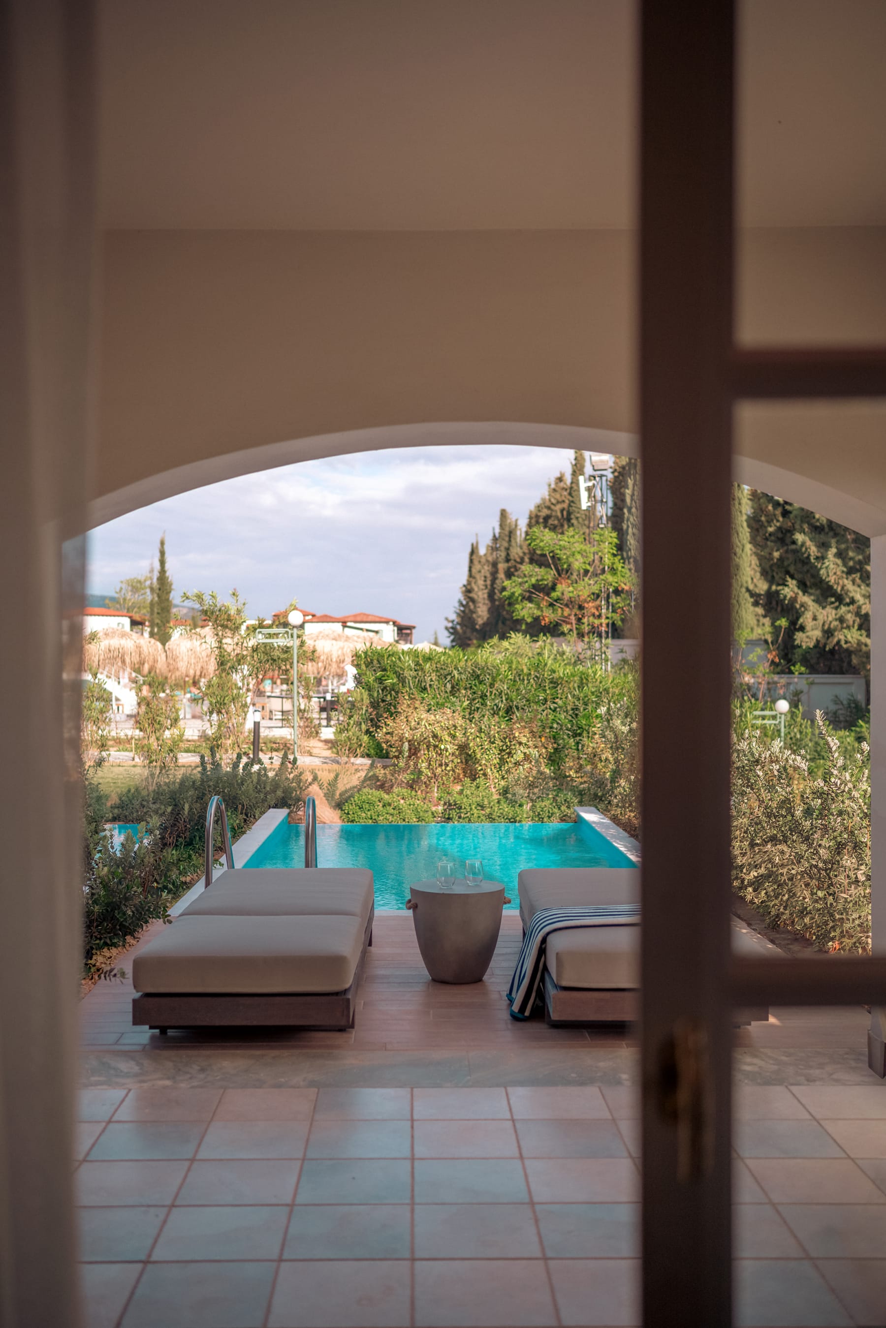 a room with a pool and chairs