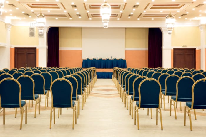 a room with rows of blue tables