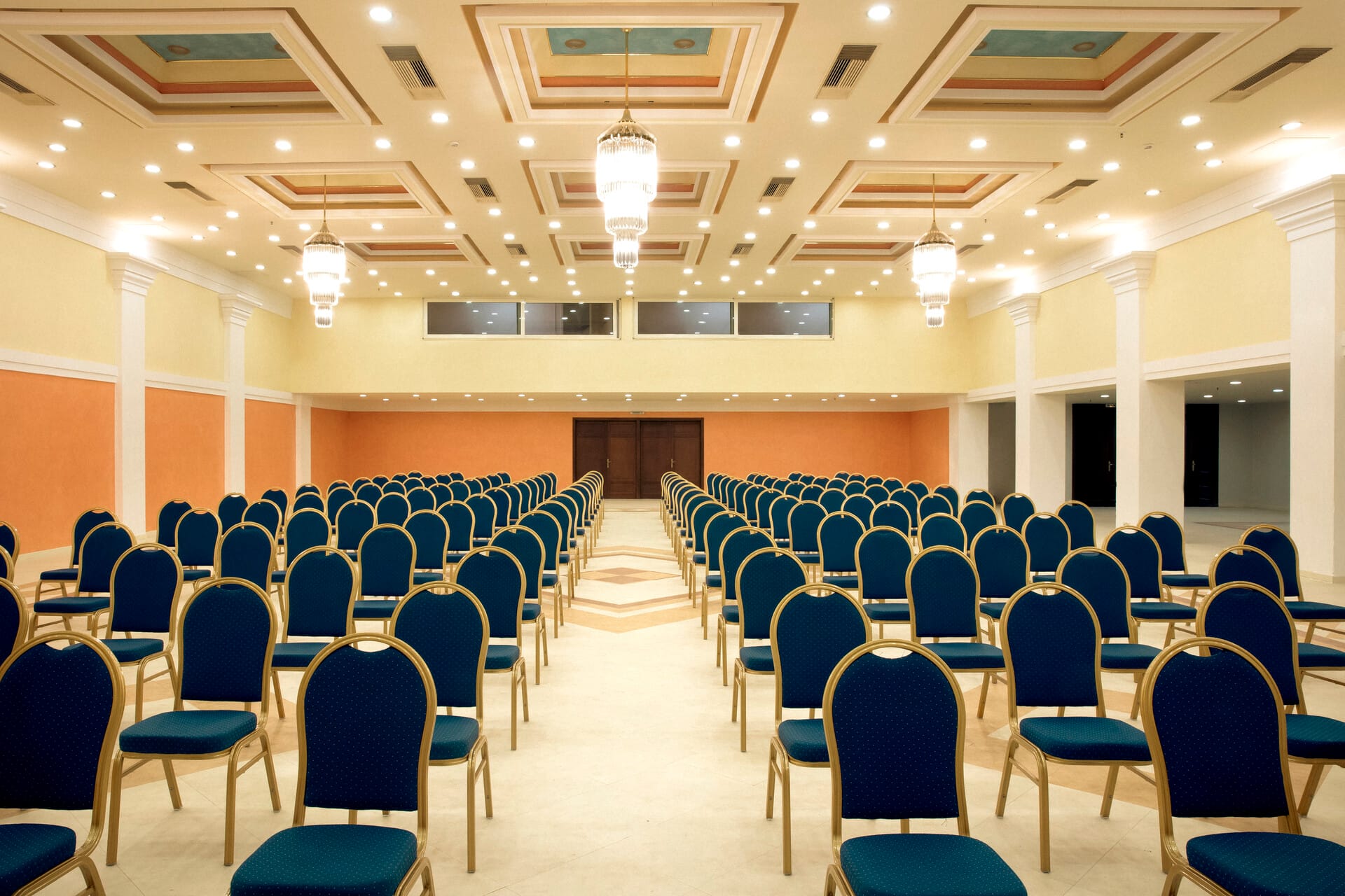 a room with rows of blue chairs