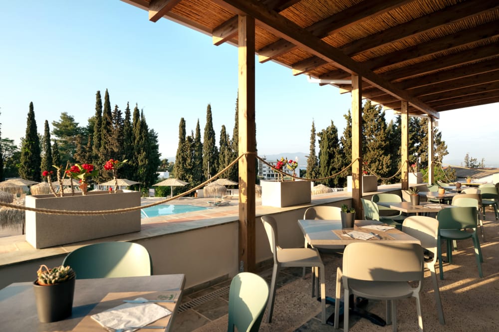 a pool with chairs and tables
