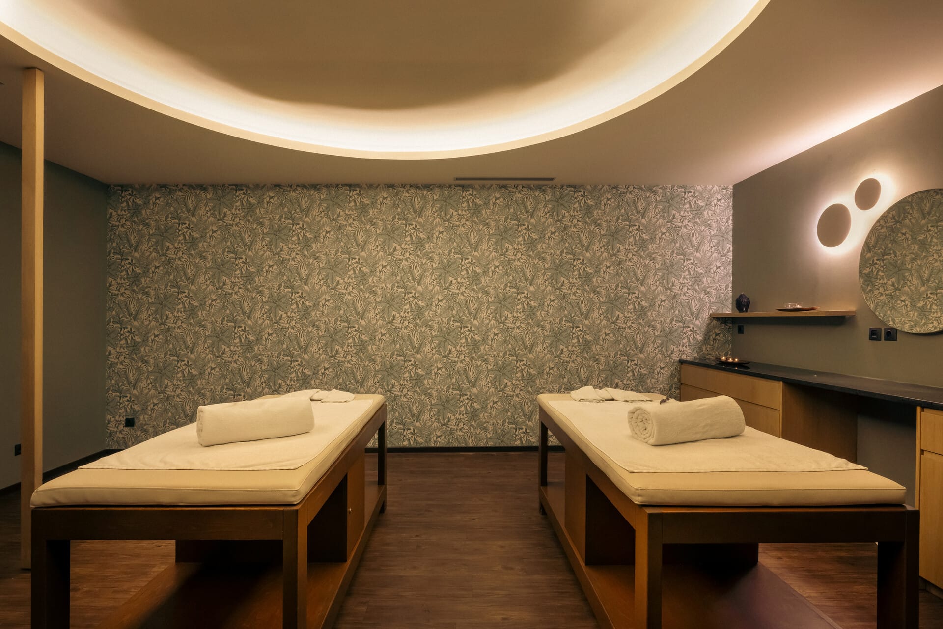 a room with desks and a wall with a green wall