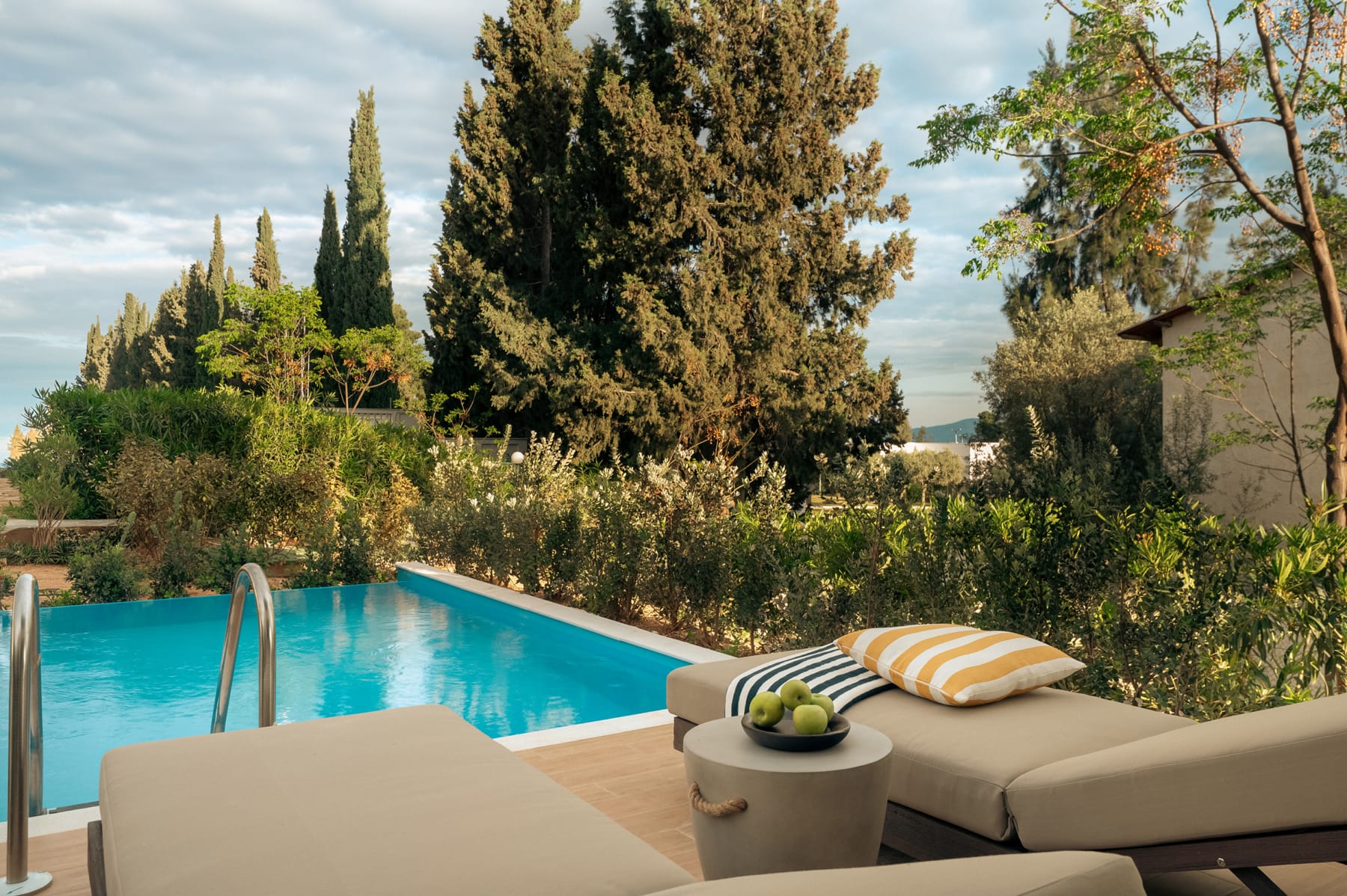 a pool with a couch and a chair by it