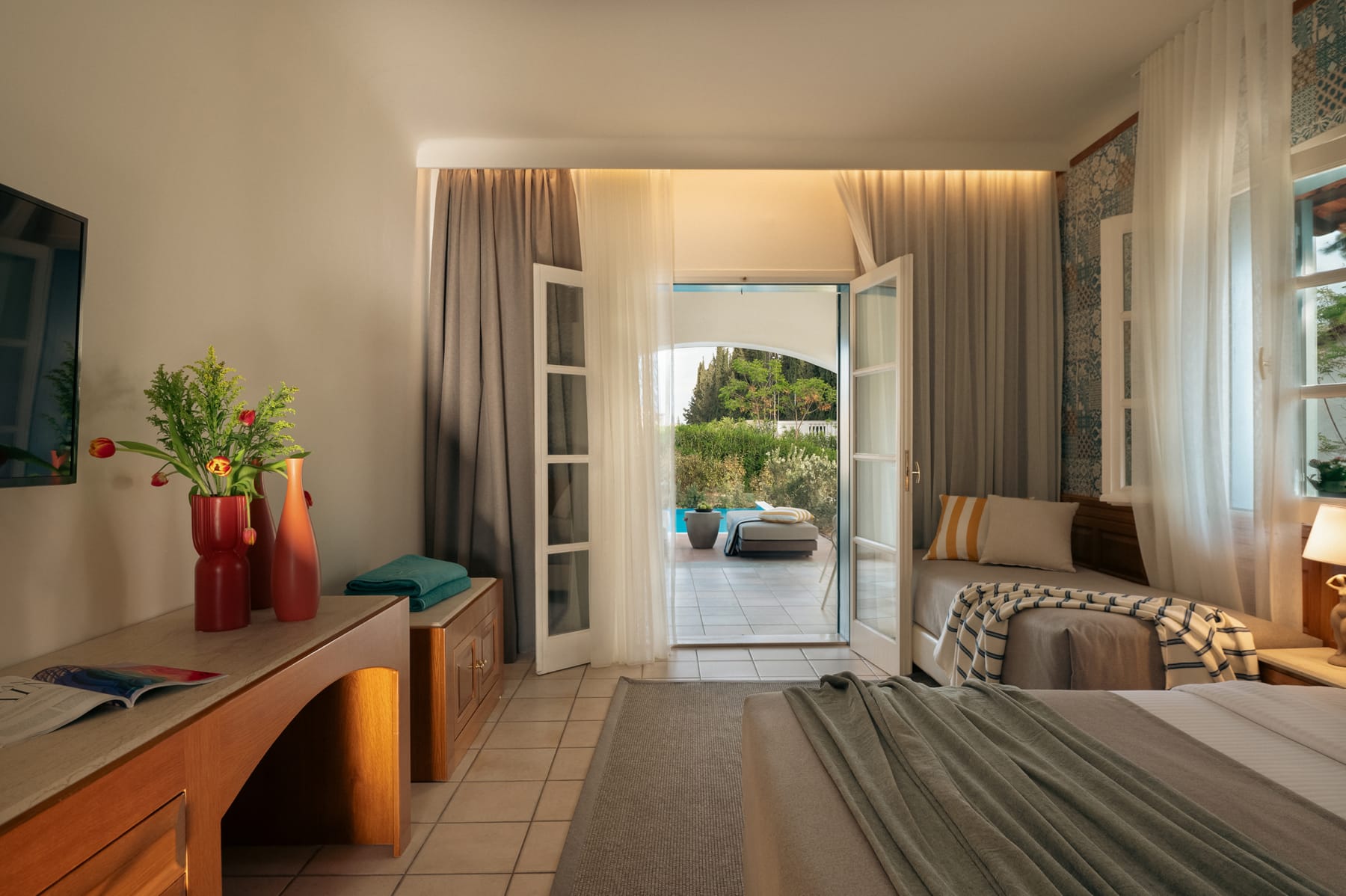 a bedroom with a large glass door