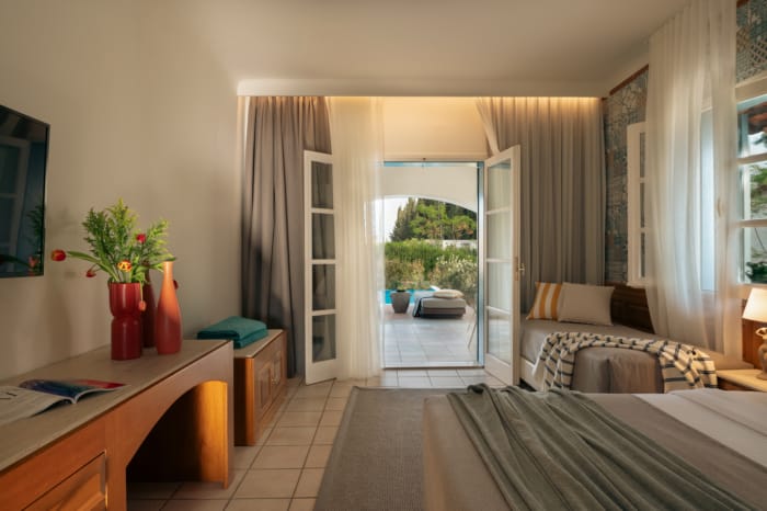 a bedroom with a large glass door