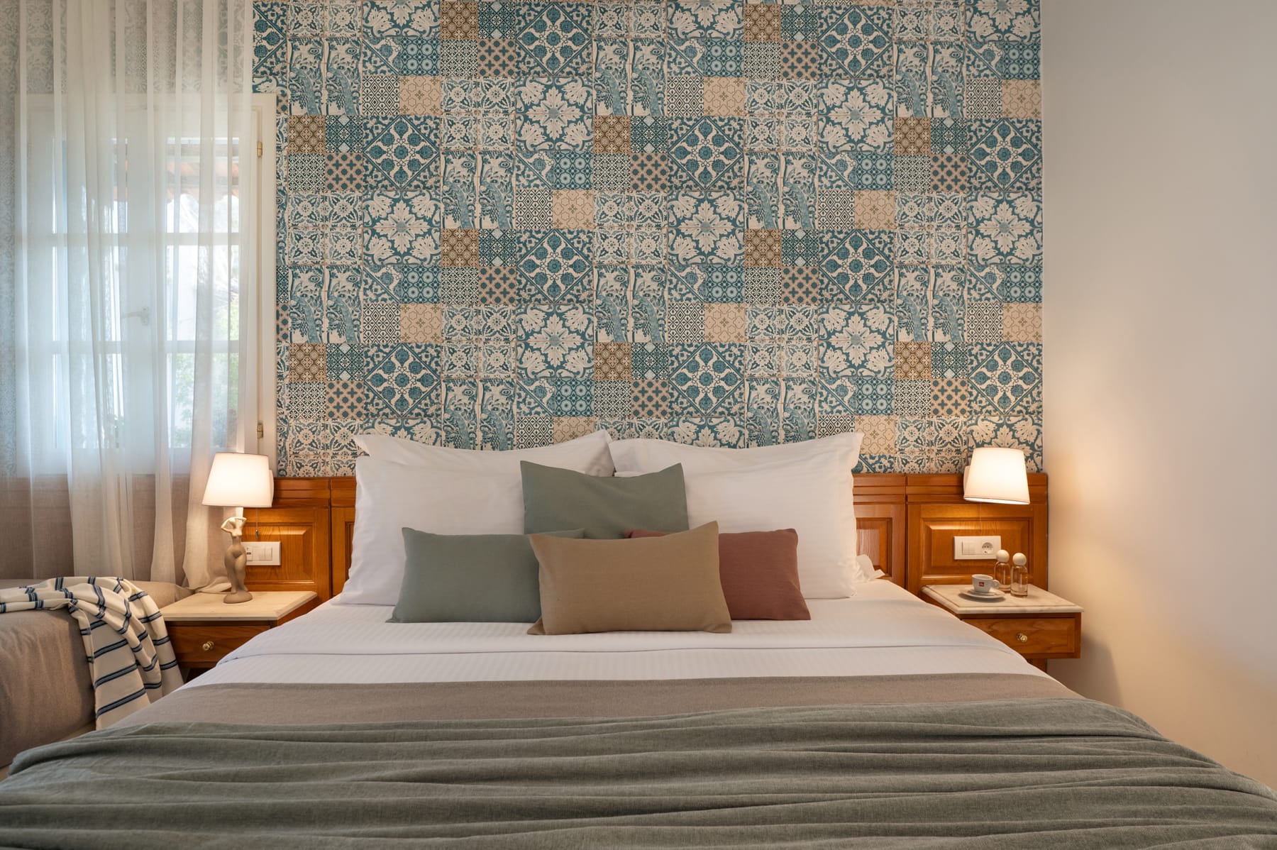 a bed with a floral wallpaper