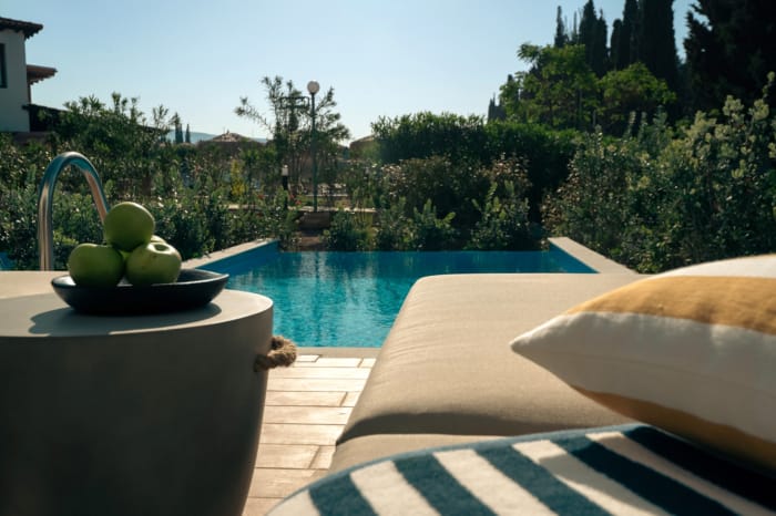 a pool with a deck and a chair by it
