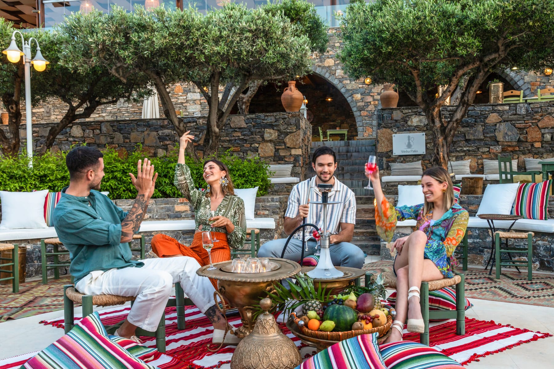 a group of people sitting around a table outside