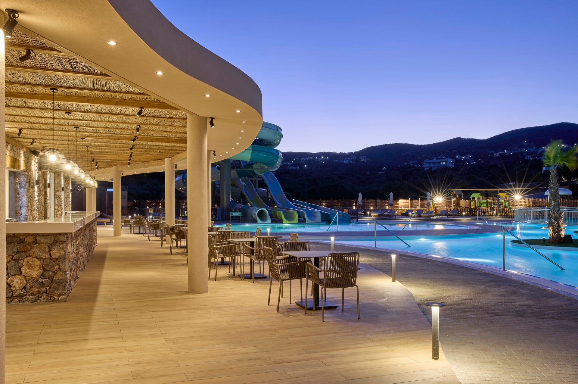 a pool with a deck and chairs by it