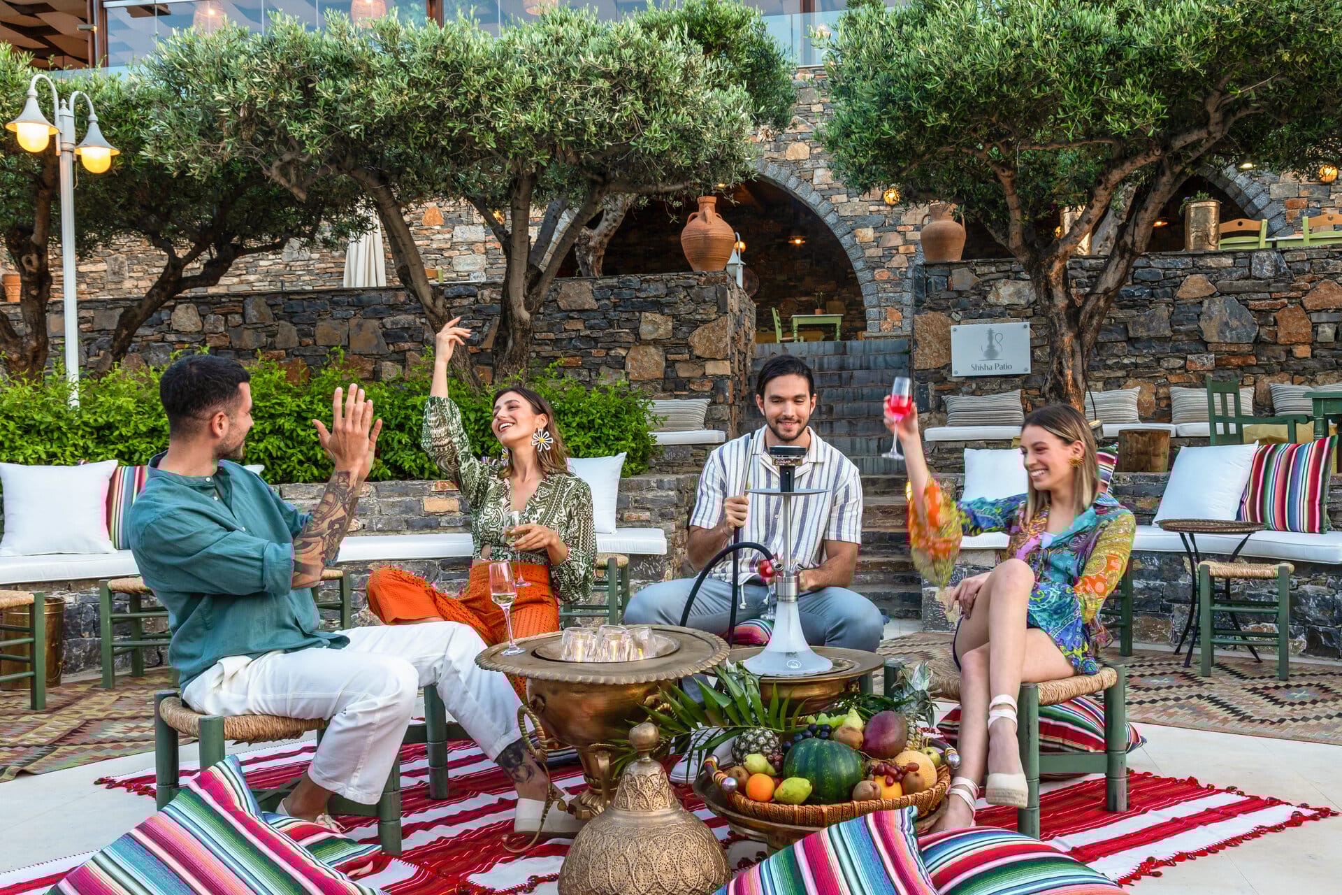 a group of people sitting around a table outside