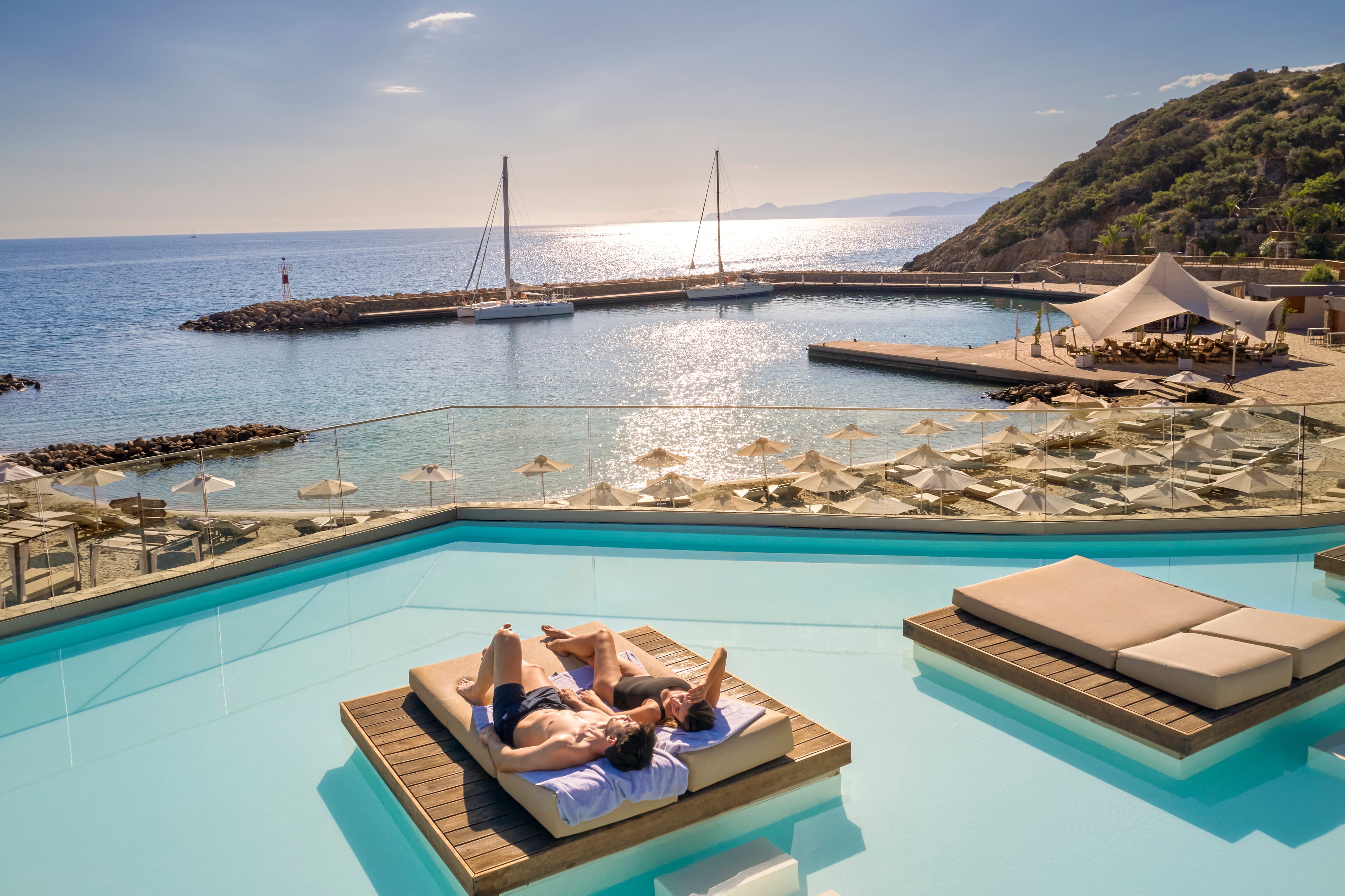 a person and person lying on a pool