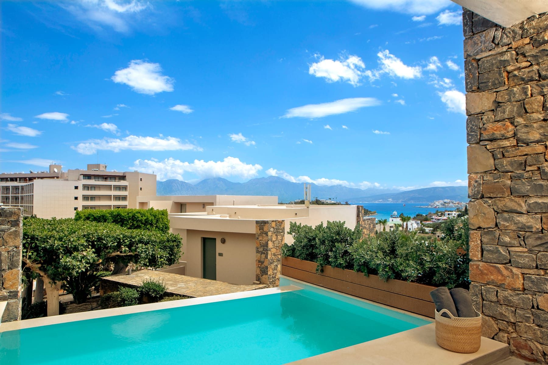 a pool with a deck and a chair in front of a building