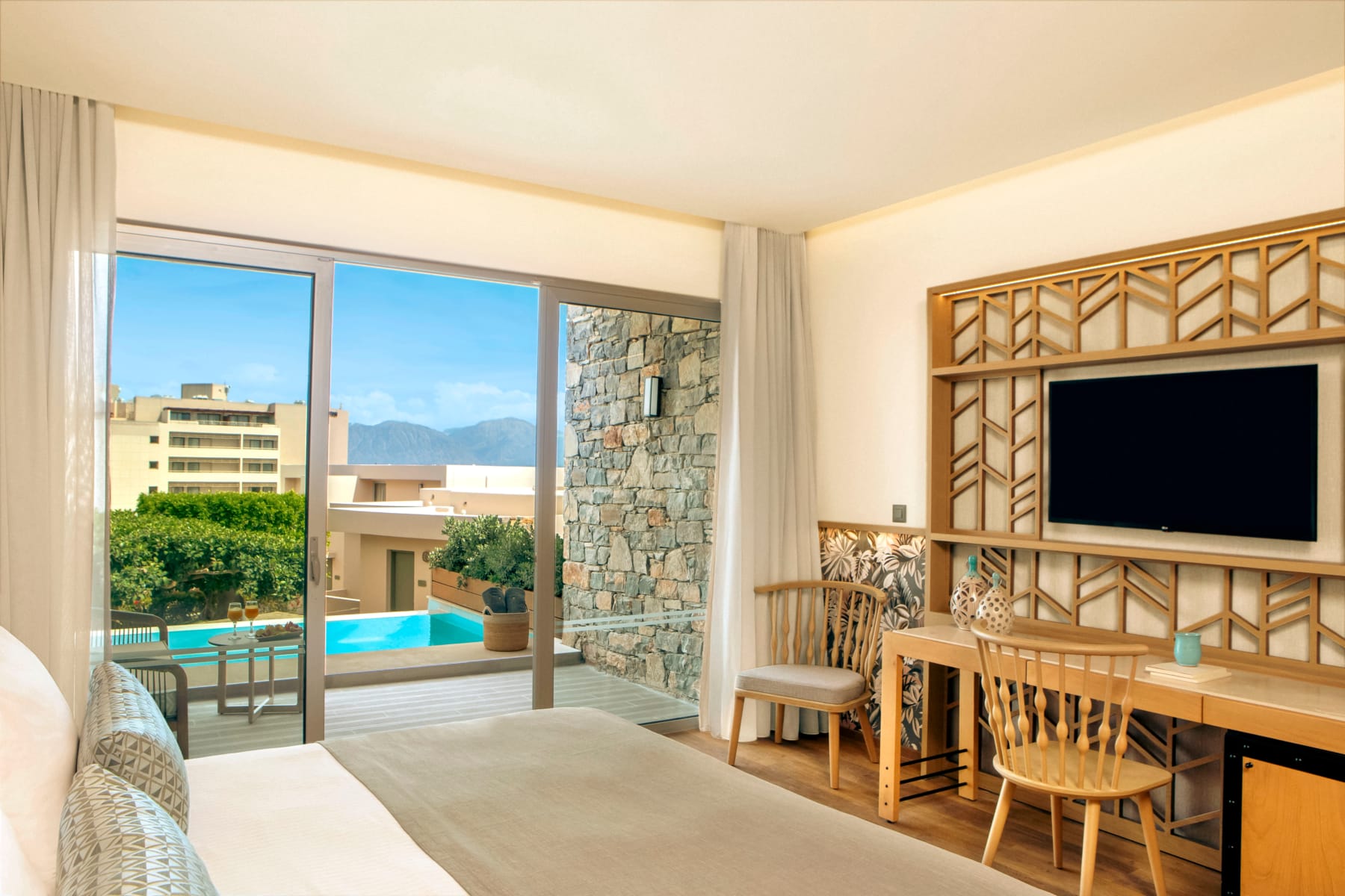 a room with a bed and a television