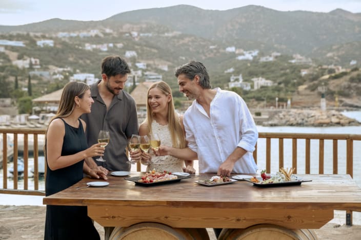 a group of people drinking wine at a table